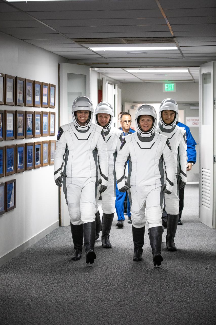 NASA’s SpaceX Crew-10 crew members walk out of the Neil A. Armstrong Operations and Checkout Building at the agency’s Kennedy Space Center in Florida ahead of launch on Friday, March 14, 2025. NASA astronauts Nichole Ayers (front, left) and Anne McClain (front, right), along with JAXA (Japan Aerospace Exploration Agency) astronaut Takuya Onishi (second row, right) and Roscosmos cosmonaut Kirill Peskov (second row, left) are scheduled to lift off aboard SpaceX’s Dragon spacecraft and Falcon 9 rocket at 7:03 p.m. EDT, from Launch Complex 39A at NASA Kennedy. Crew-10 is the tenth crew rotation mission with SpaceX to the space station as part of the agency’s Commercial Crew Program.
