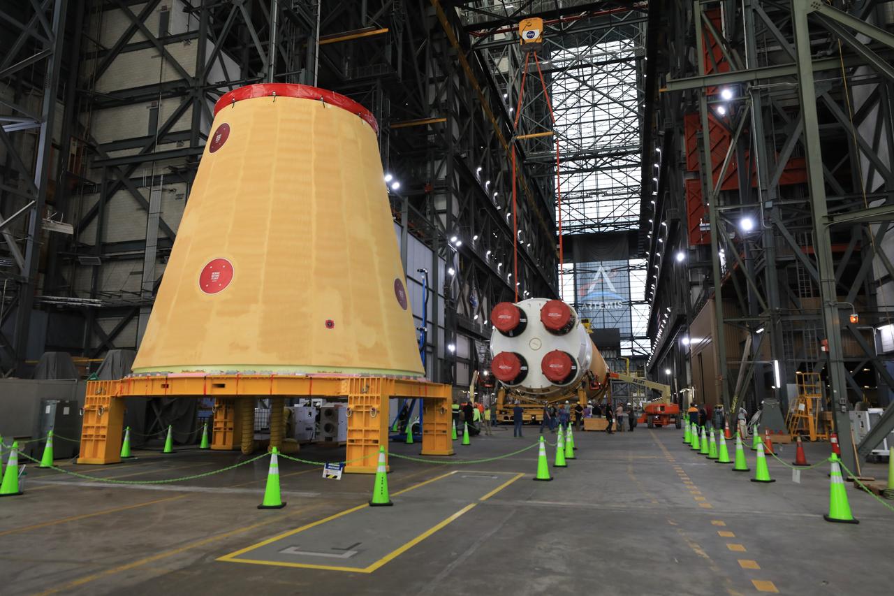 Technicians from NASA’s Exploration Ground Systems use massive cranes inside the agency’s Vehicle Assembly Building (VAB) to lift the fully assembled SLS (Space Launch System) core stage vertically 225 feet above the ground from High Bay 2 to a horizontal position in the facility’s transfer aisle at NASA’s Kennedy Space Center in Florida on Friday, March 14, 2025. The 212-foot core stage will undergo final checkouts before being lifted into the VAB’s High Bay 3 for integration alongside the completed stack of twin solid rocket booster segments.