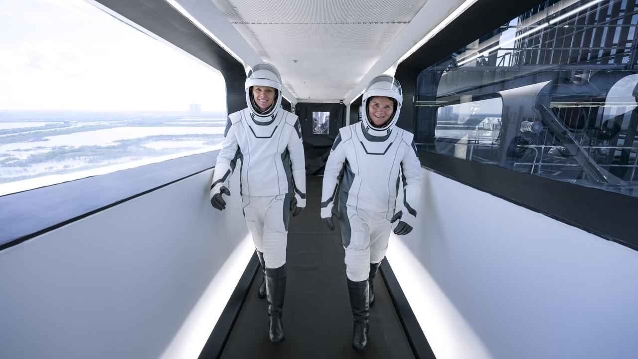 NASA astronauts Anne McClain and Nichole Ayers  walk through the crew access arm connecting the launch tower to the SpaceX Dragon spacecraft ahead NASA’s SpaceX Crew-10 mission launch on Friday, March 14, 2025. The 10th crew rotation mission with SpaceX to the space station as part of the agency’s Commercial Crew Program, Crew-10 is scheduled to lift off aboard SpaceX’s Dragon spacecraft and Falcon 9 rocket at 7:03 p.m. EDT, from Launch Complex 39A at NASA Kennedy.