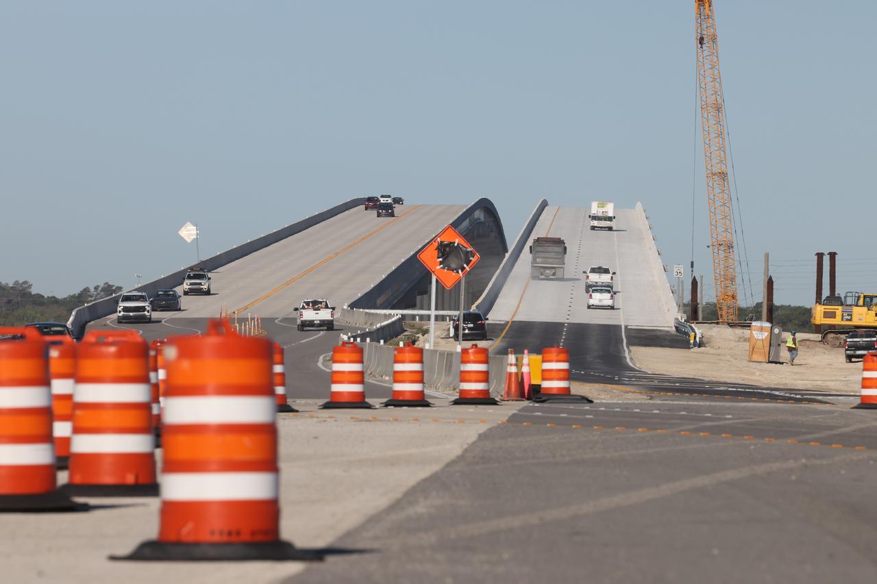 Cars drive over the newly completed westbound portion (right side of photo) of the NASA Causeway Bridge leading away from NASA’s Kennedy Space Center in Florida on Wednesday, March 19, 2025. The Florida Department of Transportation (FDOT) opened the span on Tuesday, March 18, 2025, alongside its twin on the eastbound side, which has accommodated traffic in both directions since FDOT opened it on June 9, 2023. The high-rise bridge spans the Indian River Lagoon and connects NASA Kennedy and the Cape Canaveral Space Force Station to the mainland via State Road 405/NASA Causeway in Titusville, replacing the two-lane drawbridge built in the mid-1960s to support the Apollo program.