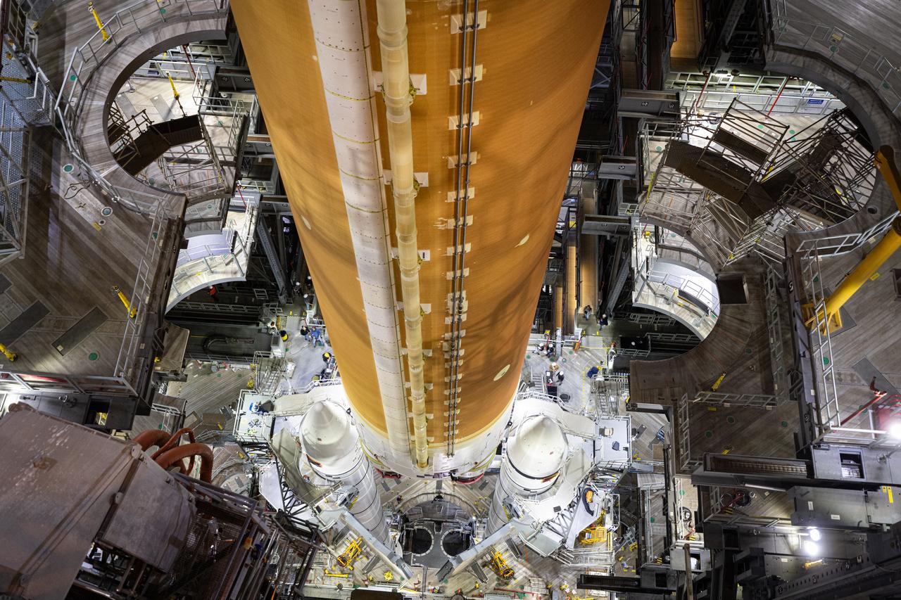 Teams with NASA’s Exploration Ground Systems and primary contractor Amentum, integrate the SLS (Space Launch System) Moon rocket with the solid rocket boosters onto mobile launcher 1 inside High Bay 3 of the Vehicle Assembly Building at NASA’s Kennedy Space Center on Sunday, March 23, 2025. Artemis II is the first crewed test flight under NASA’s Artemis campaign and is another step toward missions on the lunar surface and helping the agency prepare for future human missions to Mars.