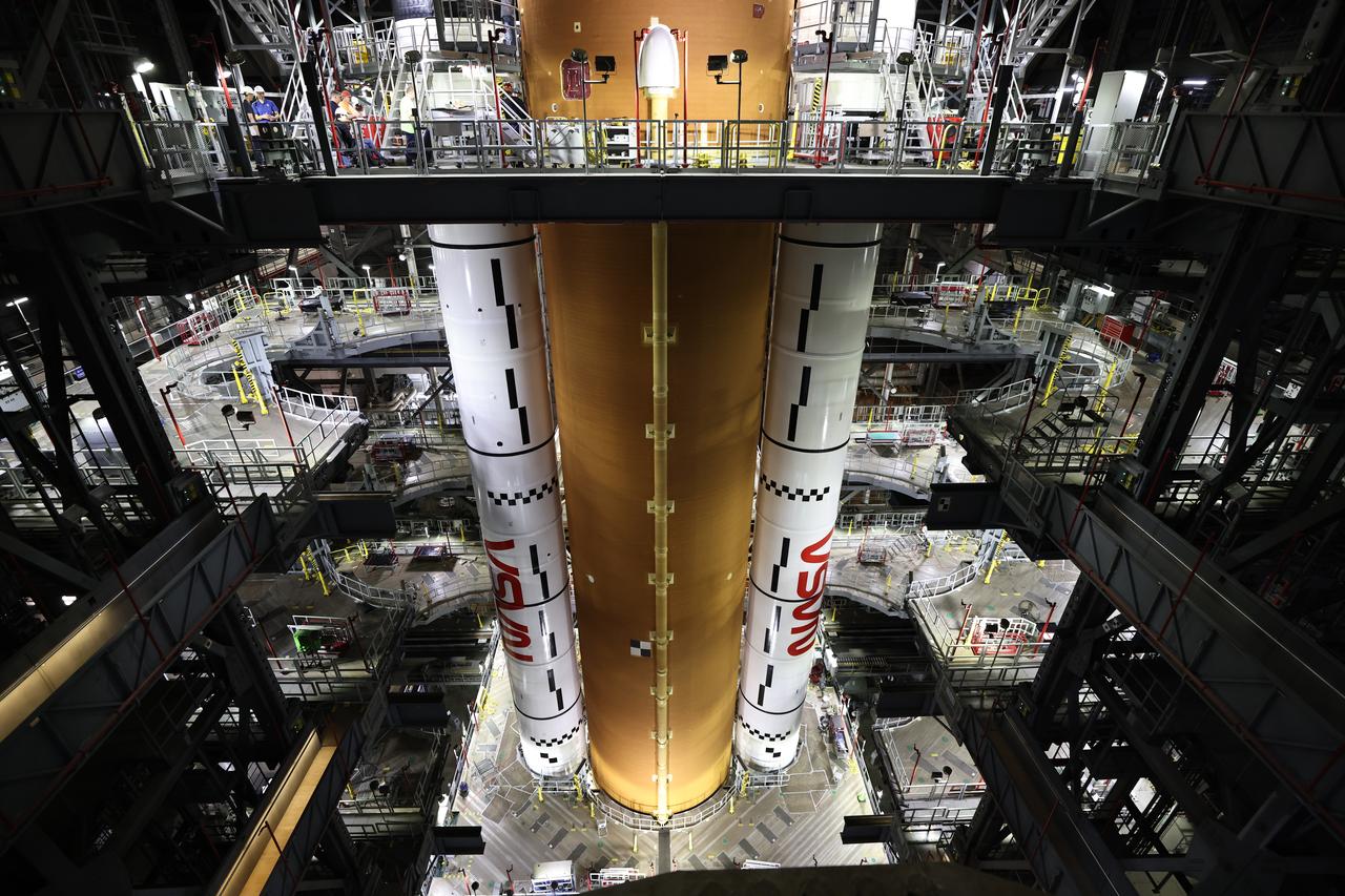 Teams with NASA’s Exploration Ground Systems and primary contractor Amentum, integrate the SLS (Space Launch System) Moon rocket with the solid rocket boosters onto mobile launcher 1 inside High Bay 3 of the Vehicle Assembly Building at NASA’s Kennedy Space Center on Sunday, March 23, 2025. Artemis II is the first crewed test flight under NASA’s Artemis campaign and is another step toward missions on the lunar surface and helping the agency prepare for future human missions to Mars.