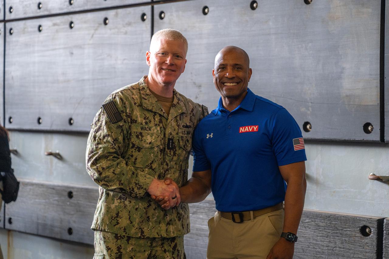 Vice Adm. John F. G. Wade, commander, U.S. 3rd Fleet, left, and NASA Artemis II Mission Pilot, Victor Glover, pose for a photo in the well deck of amphibious transport dock USS Somerset (LPD 25) ahead of NASA Underway Recovery Test 12 on Naval Base San Diego, March 25, 2025. In preparation for NASA's Artemis II crewed mission, which will send four astronauts around the moon and beyond in the Orion spacecraft, NASA and the Department of Defense will conduct a series of tests to demonstrate and evaluate the processes, procedures, and hardware used in recovery operations for crewed lunar missions.
