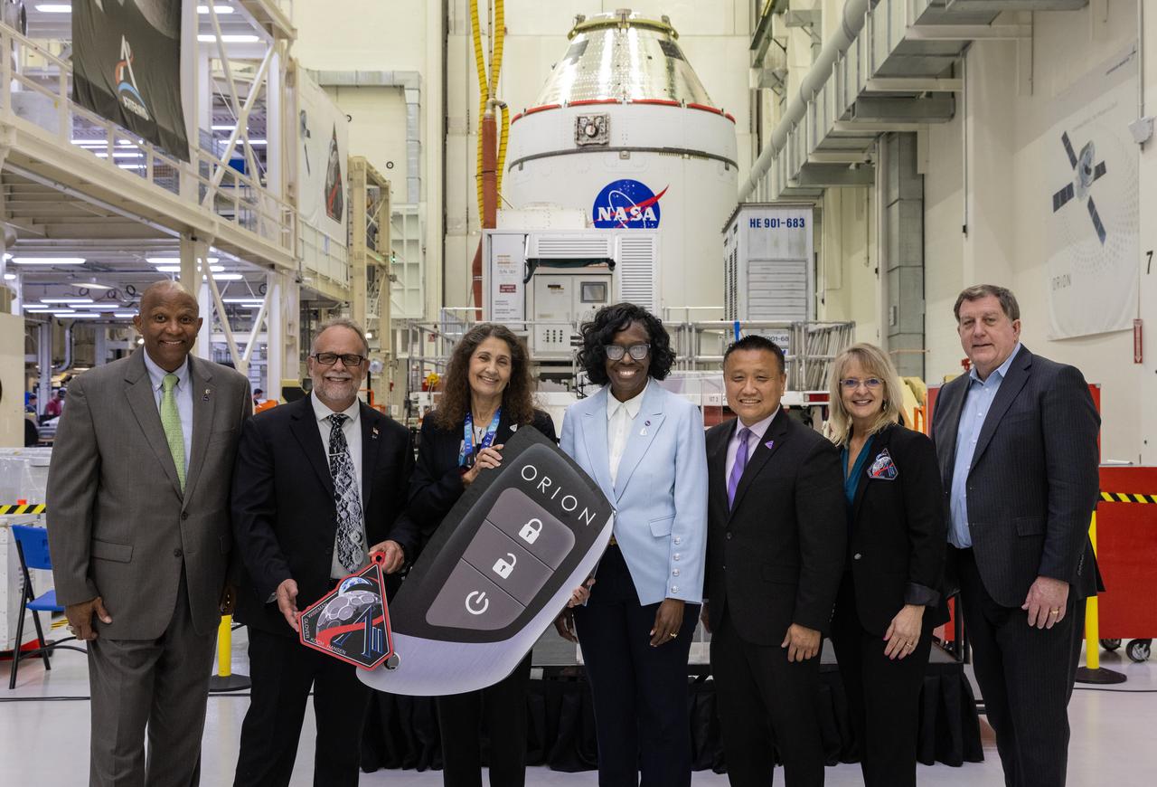 From left, Kelvin Manning, acting center director, NASA’s Kennedy Space Center; Shawn Quinn, Exploration Ground Systems program manager; Lorna Kenna, Amentum Vice President and program manager; Lakiesha Hawkins, assistant deputy associate administrator, Moon to Mars Program office; Howard Hu, Orion program manager; Debbie Korth, Orion deputy program manager; Keith Shireman Lockheed Martin Vice President of Lunar Exploration Campaign, participate in a handover ceremony of NASA’s Artemis II Orion spacecraft to crews with the agency’s Exploration Ground Systems Program at the Neil A. Armstrong Operations and Checkout Building at NASA’s Kennedy Space Center in Florida on Thursday, May 1, 2025. The spacecraft will be transported to the Multi-Payload Processing Facility to undergo fueling and processing for prelaunch operations. The Artemis II test flight is the first crewed flight under NASA’s Artemis campaign and is another step toward missions on the lunar surface and helping the agency prepare for future human missions to Mars. 