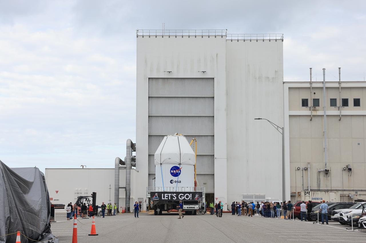 NASA’s KAMAG transporter carries the agency’s Artemis II Orion spacecraft from the Neil A. Armstrong Operations and Checkout Building to the Multi-Payload Processing Facility at Kennedy Space Center in Florida on Saturday, May 3, 2025. The Orion spacecraft will undergo fueling and processing operations at the Multi-Function Facility. The Artemis II test flight is the first crewed flight under NASA’s Artemis campaign and is another step toward missions on the lunar surface and helping the agency prepare for future human missions to Mars.