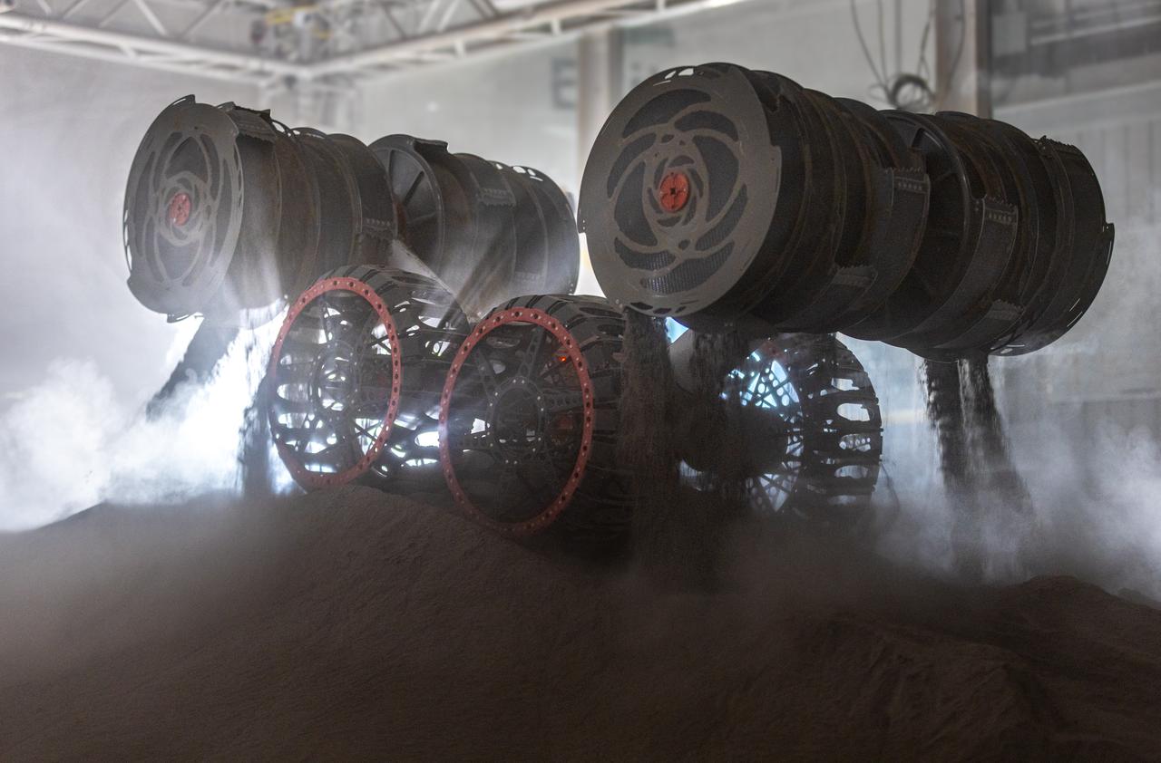 NASA’s RASSOR (Regolith Advanced Surface Systems Operations Robot) conducts excavation testing of simulated regolith, or lunar dust found on the Moon’s surface, inside of the Granular Mechanics and Regolith Operations Lab at the agency’s Kennedy Space Center in Florida on Tuesday, May 27, 2025. RASSOR is designed to work in low-gravity situations, using counter rotating bucket drums on each arm to collect and dump regolith for the extraction of hydrogen, oxygen, or water, resources critical for sustaining a habitable presence.