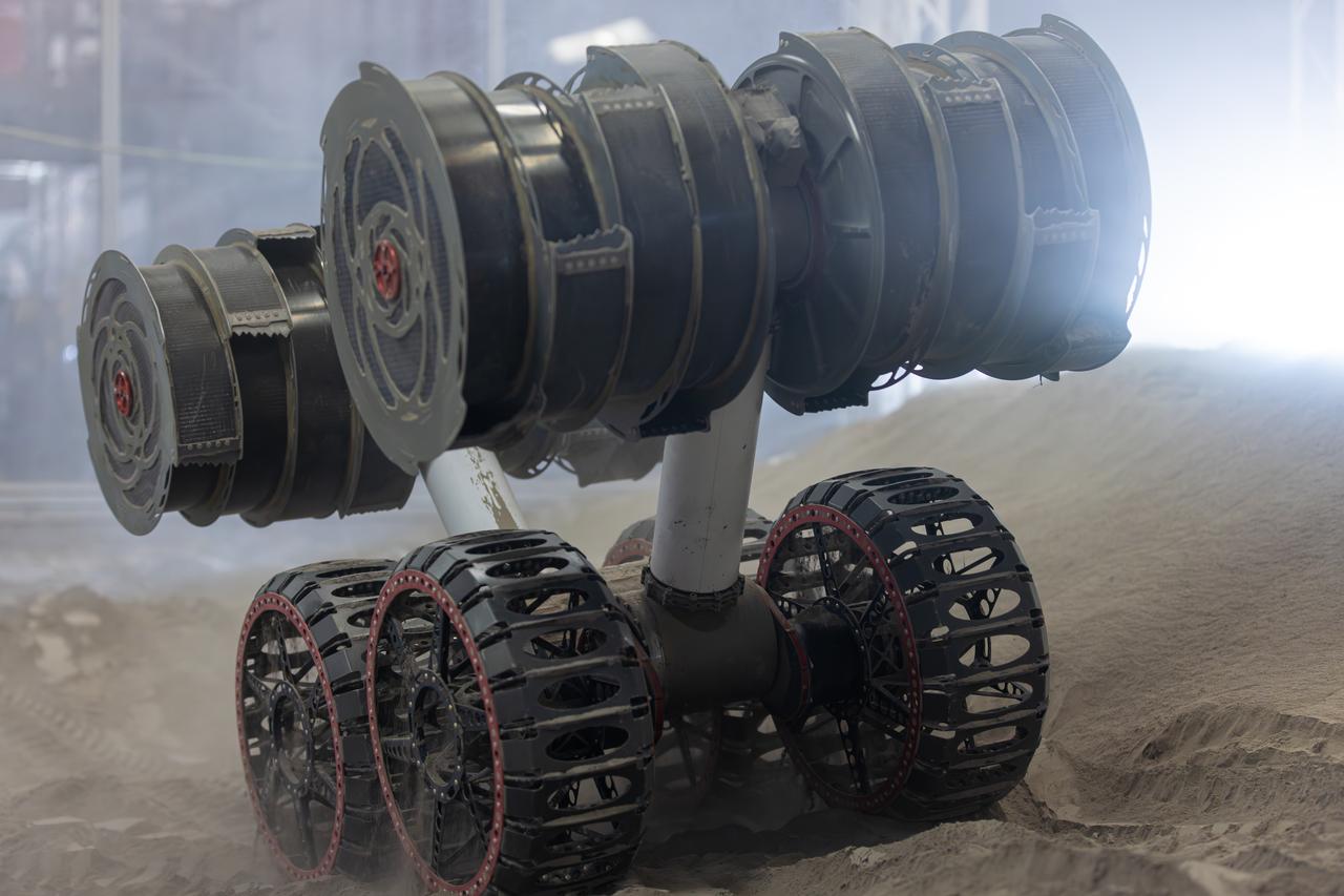 NASA’s RASSOR (Regolith Advanced Surface Systems Operations Robot) conducts excavation testing of simulated regolith, or lunar dust found on the Moon’s surface, inside of the Granular Mechanics and Regolith Operations Lab at the agency’s Kennedy Space Center in Florida on Tuesday, May 27, 2025. RASSOR is designed to work in low-gravity situations, using counter rotating bucket drums on each arm to collect and dump regolith for the extraction of hydrogen, oxygen, or water, resources critical for sustaining a habitable presence.