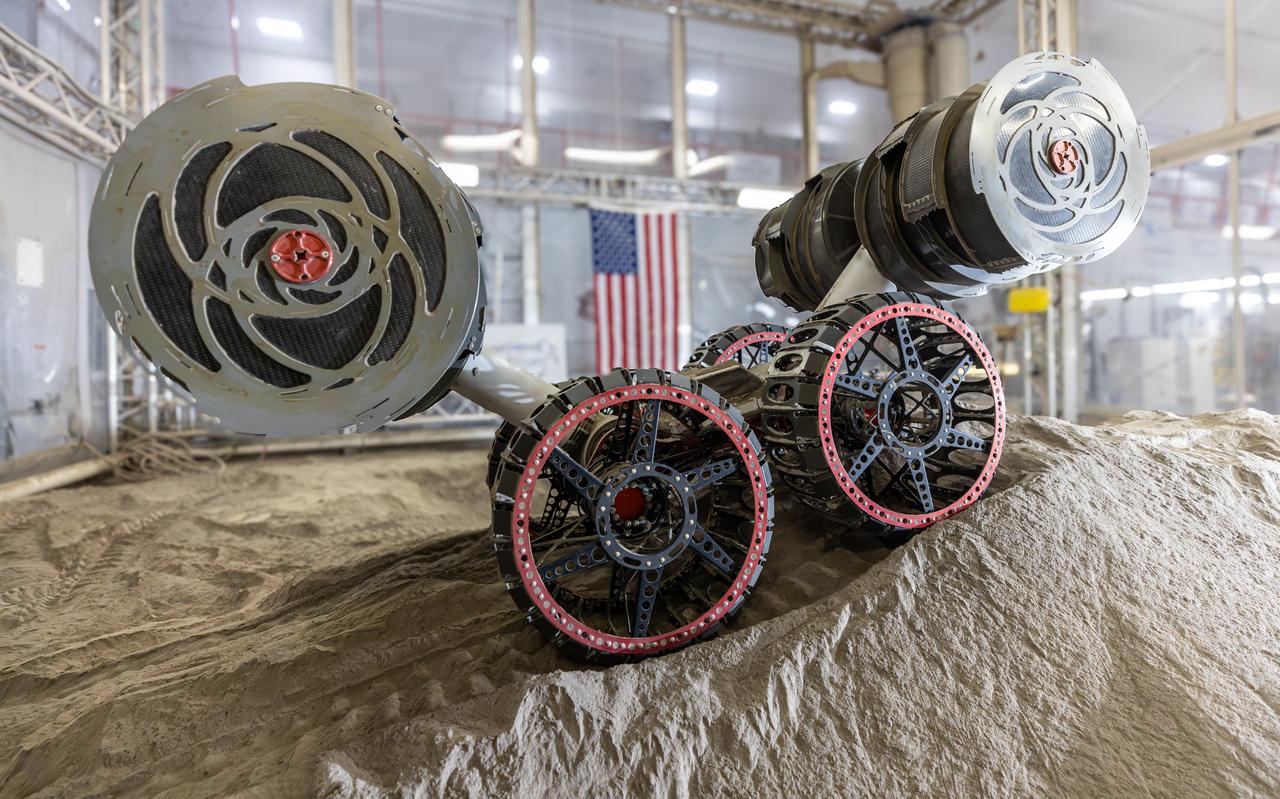 NASA’s RASSOR (Regolith Advanced Surface Systems Operations Robot) conducts excavation testing of simulated regolith, or lunar dust found on the Moon’s surface, inside of the Granular Mechanics and Regolith Operations Lab at the agency’s Kennedy Space Center in Florida on Tuesday, May 27, 2025. RASSOR is designed to work in low-gravity situations, using counter rotating bucket drums on each arm to collect and dump regolith for the extraction of hydrogen, oxygen, or water, resources critical for sustaining a habitable presence.