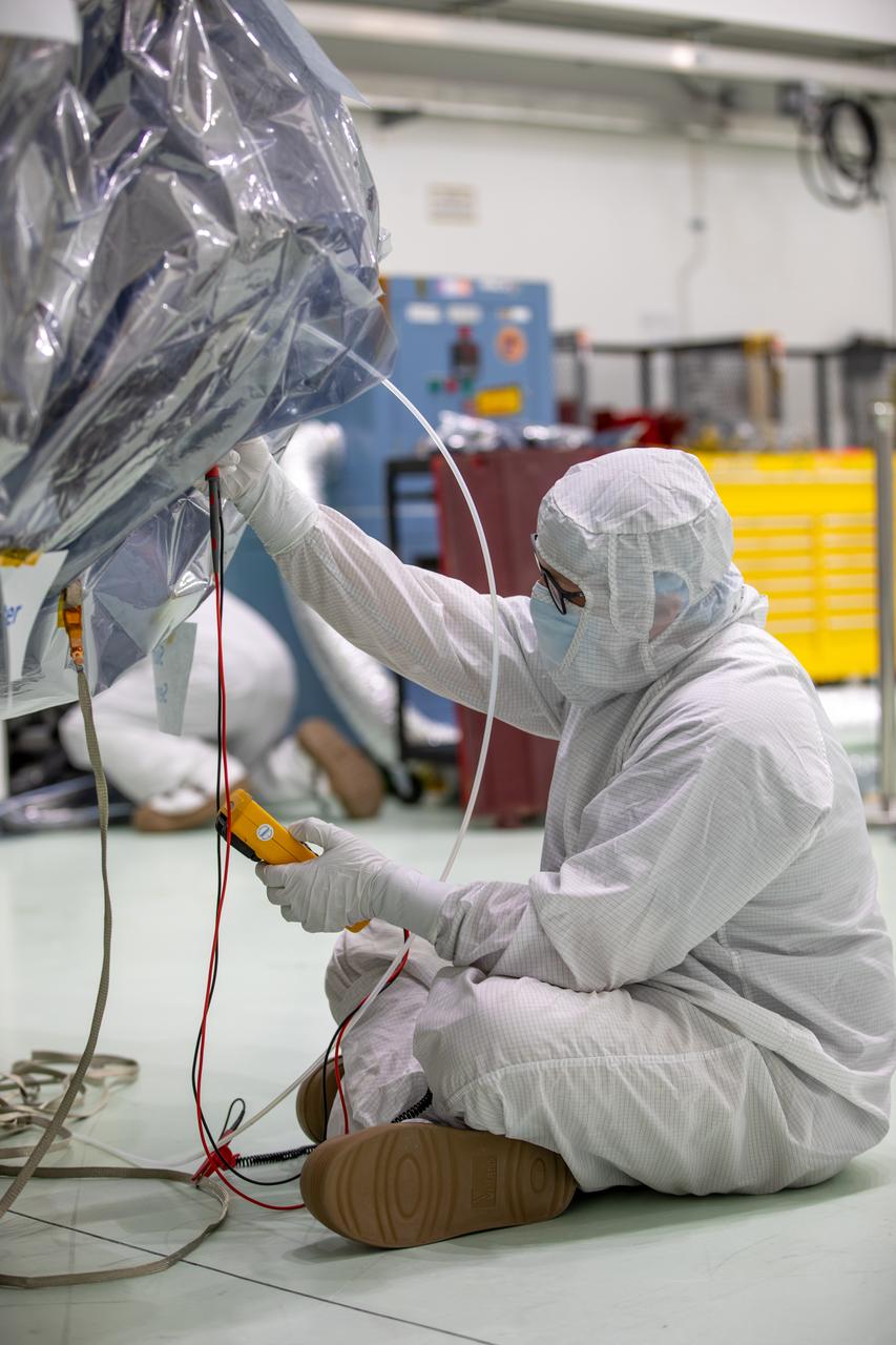 Technicians perform status checks on NASA’s IMAP (Interstellar Mapping and Acceleration Probe) spacecraft after removal from its shipping container inside the high bay at the Astrotech Space Operations Facility near the agency’s Kennedy Space Center in Florida on Thursday, May 29, 2025. The observatory will study how the Sun shapes the boundaries of the heliosphere, the bubble protecting around our solar system, and is targeted for launch this fall aboard a SpaceX Falcon 9 rocket from Launch Complex 39A at NASA Kennedy.  
