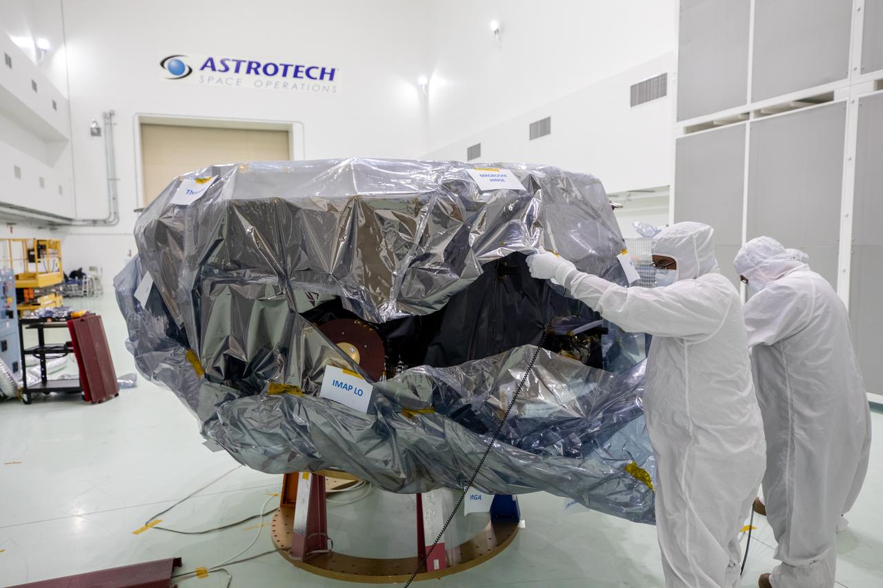Technicians remove protective coverings form NASA’s IMAP (Interstellar Mapping and Acceleration Probe) inside the high bay at the Astrotech Space Operations Facility near the agency’s Kennedy Space Center in Florida on Thursday, May 29,2025. The observatory will study how the Sun shapes the boundaries of the heliosphere, the bubble protecting around our solar system, and is targeted for launch this fall aboard a SpaceX Falcon 9 rocket from Launch Complex 39A at NASA Kennedy. 