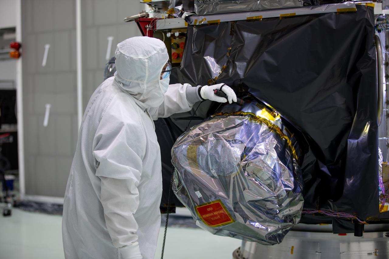 Technicians remove protective coverings form NASA’s IMAP (Interstellar Mapping and Acceleration Probe) inside the high bay at the Astrotech Space Operations Facility near the agency’s Kennedy Space Center in Florida on Thursday, May 29,2025. The observatory will study how the Sun shapes the boundaries of the heliosphere, the bubble protecting around our solar system, and is targeted for launch this fall aboard a SpaceX Falcon 9 rocket from Launch Complex 39A at NASA Kennedy. 
