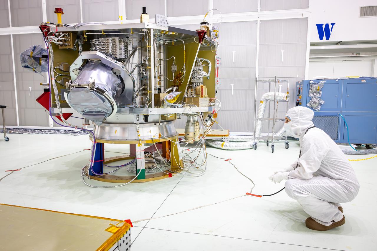Technicians test the spring-activated door on the Interstellar Dust Experiment (IDEX) instrument of NASA’s IMAP (Interstellar Mapping and Acceleration Probe) observatory inside the high bay at the Astrotech Space Operations Facility near the agency’s Kennedy Space Center in Florida on Tuesday, June 3, 2025. The door will remain closed to protect IDEX from contamination during integration and launch. Once in space, the door will swing open permanently to allow interstellar and interplanetary dust to flow into the instrument for measurement. The IMAP observatory will study how the Sun shapes the boundaries of the heliosphere, the protective bubble around our solar system. Launch is targeted for no earlier than September 2025 aboard a SpaceX Falcon 9 rocket from Launch Complex 39A at NASA Kennedy.