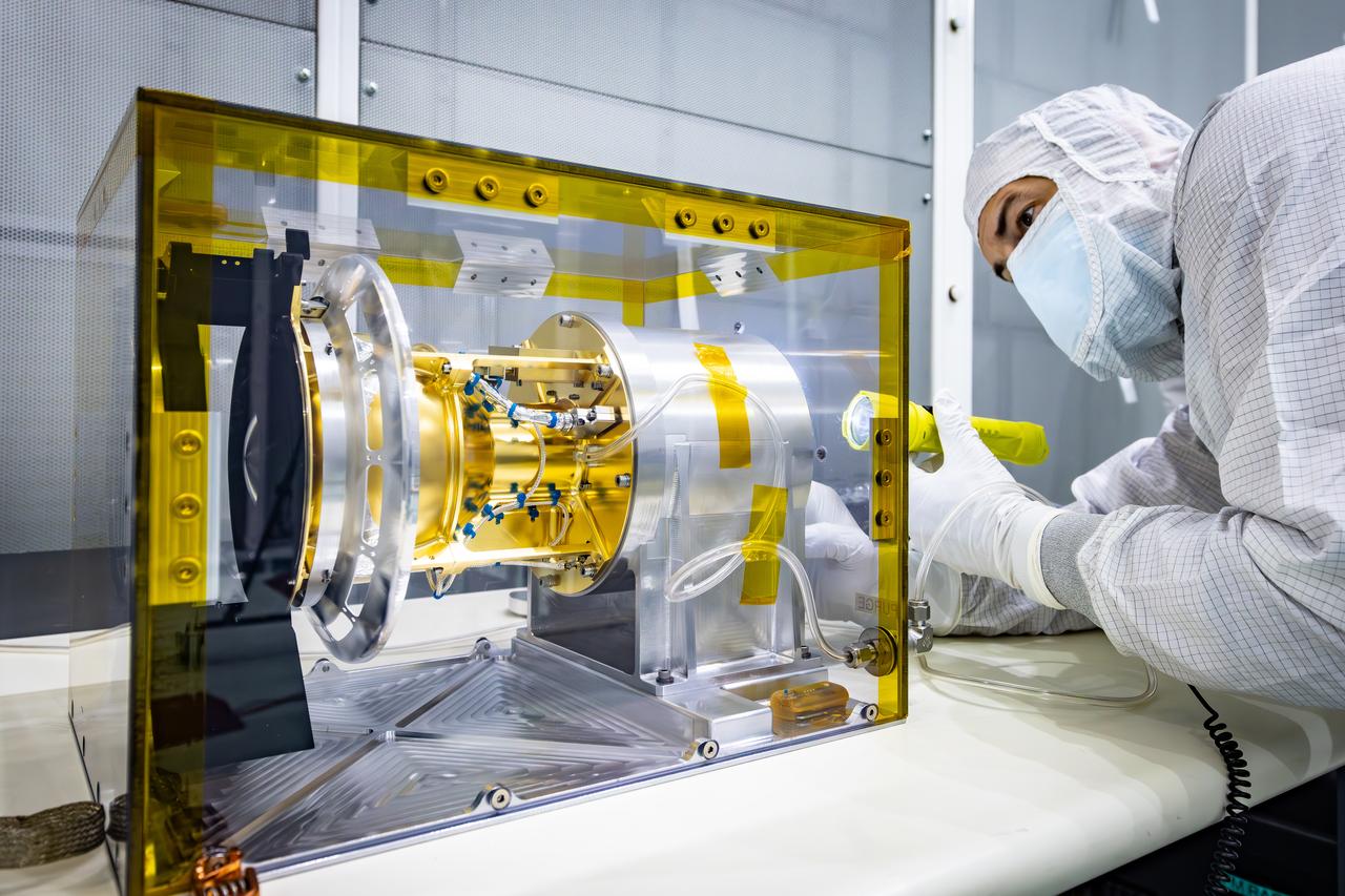 Technicians perform tests the Solar Wind and Pickup Ions (SWAPI) instrument of NASA’s IMAP (Interstellar Mapping and Acceleration Probe) observatory inside the high bay at the Astrotech Space Operations Facility near the agency’s Kennedy Space Center in Florida on Tuesday, June 17, 2025. As IMAP spins in space, solar wind particles are swept into SWAPI through a special opening called “sunglasses,” an opening covered by a screen with very tiny precise holes that cut down the brightness of the very intense solar wind. SWAPI collects and counts particles from the solar wind flowing from the Sun and particles called pick-up ions that have entered the heliosphere from outside the solar system and traveled inwards where IMAP orbits near Earth. Launch of the IMAP mission is targeted for no earlier than September 2025 aboard a SpaceX Falcon 9 rocket from Launch Complex 39A at NASA Kennedy.