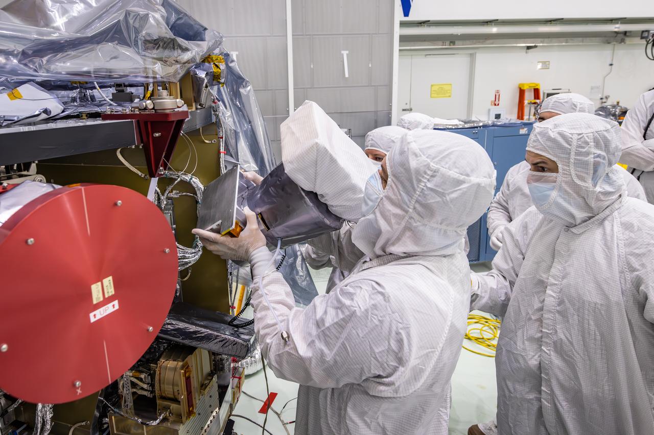 Technicians reintegrate the Solar Wind and Pickup Ions (SWAPI) instrument of NASA’s IMAP (Interstellar Mapping and Acceleration Probe) observatory inside the high bay at the Astrotech Space Operations Facility near the agency’s Kennedy Space Center in Florida on Monday, June 23, 2025. As IMAP spins in space, solar wind particles are swept into SWAPI through a special opening called “sunglasses,” an opening covered by a screen with very tiny precise holes that cut down the brightness of the very intense solar wind. SWAPI collects and counts particles from the solar wind flowing from the Sun and particles called pick-up ions that have entered the heliosphere from outside the solar system and traveled inwards where IMAP orbits near Earth. Launch of the IMAP mission is targeted for no earlier than September 2025 aboard a SpaceX Falcon 9 rocket from Launch Complex 39A at NASA Kennedy.