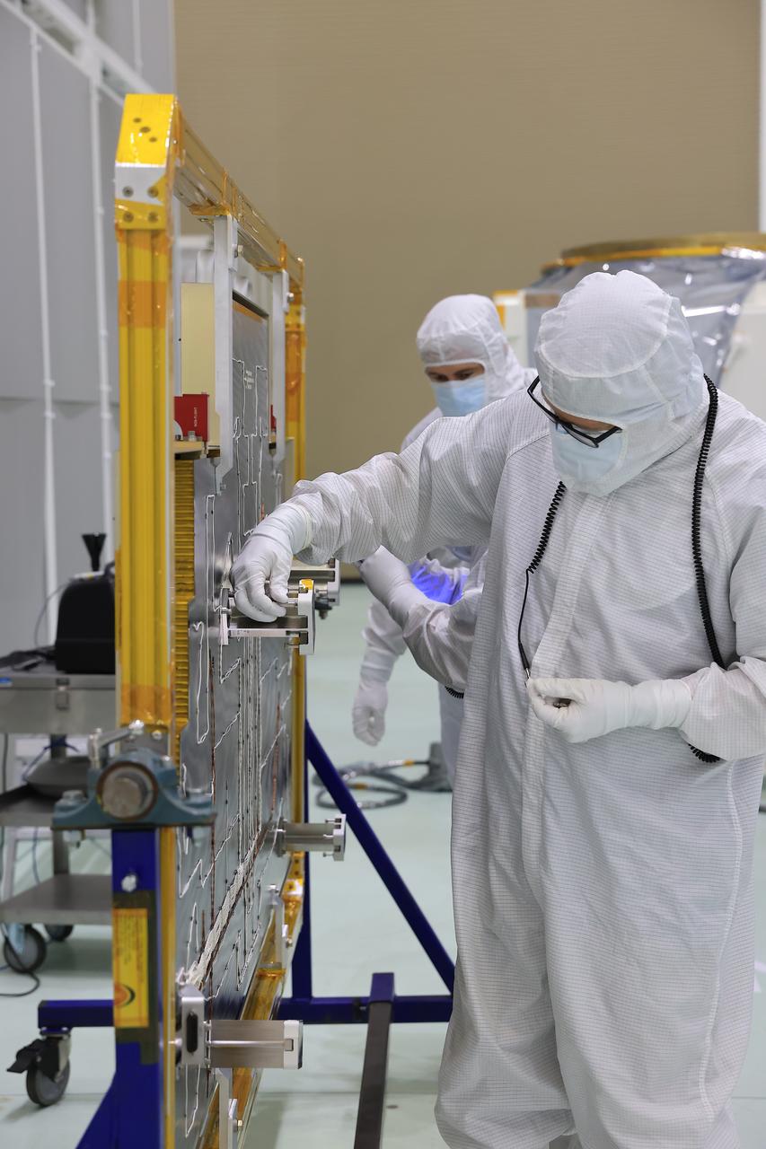 Technicians at the Astrotech Space Operations Facility near NASA’s Kennedy Space Center in Florida install the two-panel solar array on Thursday, July 17, 2025, that will help power the agency’s IMAP (Interstellar Mapping and Acceleration Probe) observatory on its upcoming journey one million miles away from Earth. Each panel of the solar array, located on the top of IMAP, consists of 16 strings of solar cells, with 36 cells per string, and combined will convert sunlight into 500 watts of power, more than enough for the observatory, which as a system uses less power than five 100-watt incandescent light bulbs.
