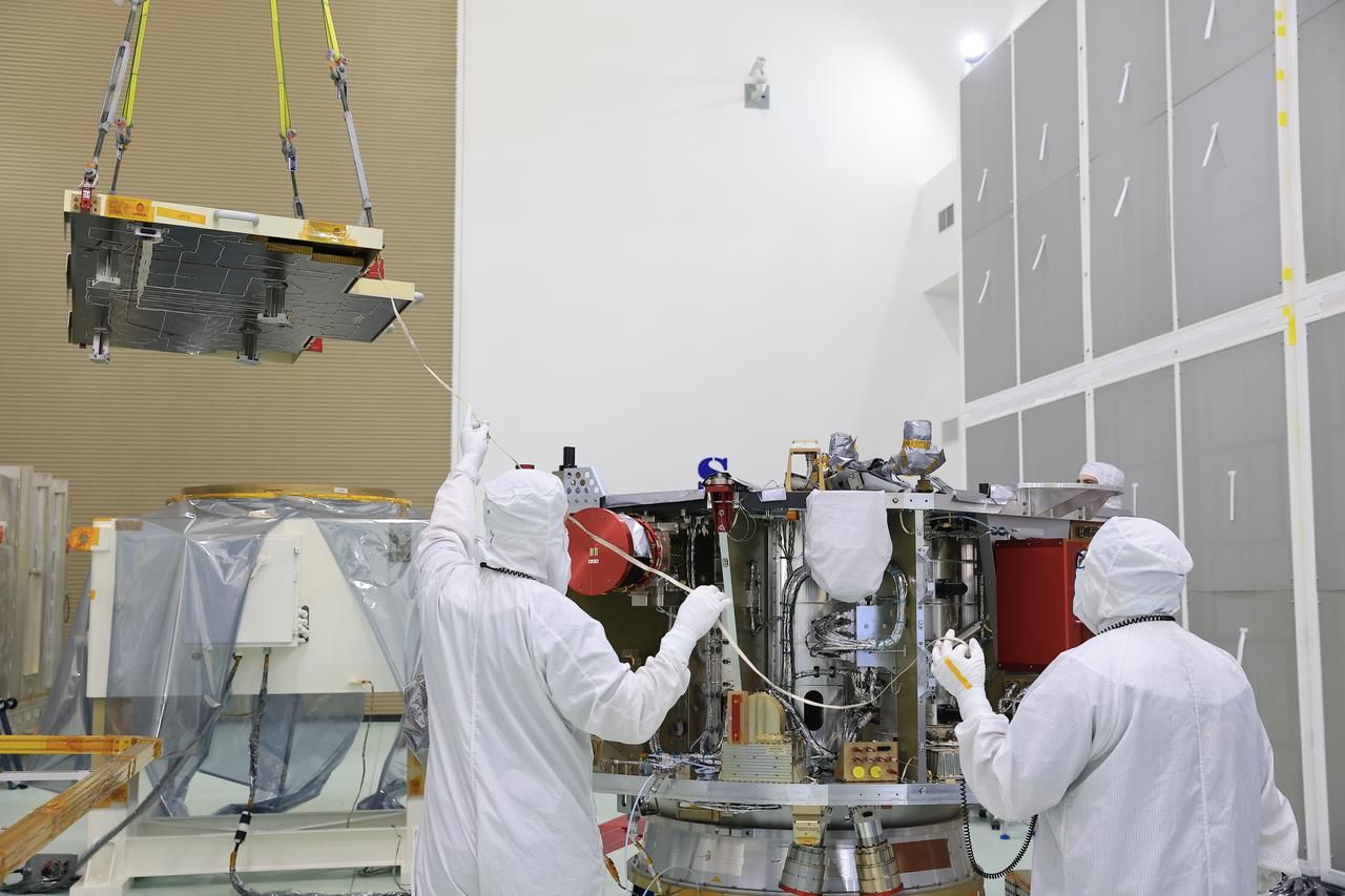 Technicians at the Astrotech Space Operations Facility near NASA’s Kennedy Space Center in Florida install the two-panel solar array on Thursday, July 17, 2025, that will help power the agency’s IMAP (Interstellar Mapping and Acceleration Probe) observatory on its upcoming journey one million miles away from Earth. Each panel of the solar array, located on the top of IMAP, consists of 16 strings of solar cells, with 36 cells per string, and combined will convert sunlight into 500 watts of power, more than enough for the observatory, which as a system uses less power than five 100-watt incandescent light bulbs.