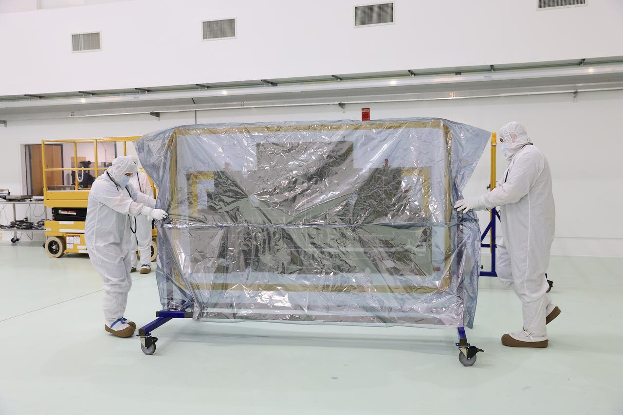 Technicians at the Astrotech Space Operations Facility near NASA’s Kennedy Space Center in Florida install the two-panel solar array on Thursday, July 17, 2025, that will help power the agency’s IMAP (Interstellar Mapping and Acceleration Probe) observatory on its upcoming journey one million miles away from Earth. Each panel of the solar array, located on the top of IMAP, consists of 16 strings of solar cells, with 36 cells per string, and combined will convert sunlight into 500 watts of power, more than enough for the observatory, which as a system uses less power than five 100-watt incandescent light bulbs.