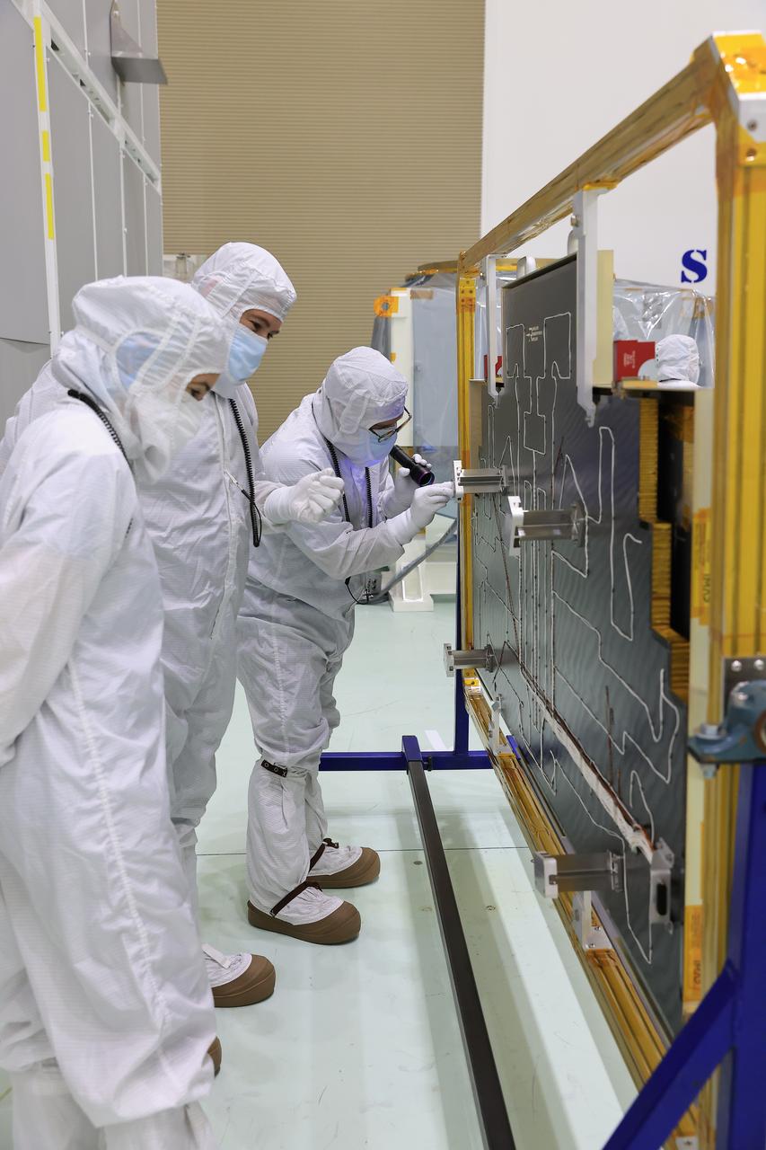 Technicians at the Astrotech Space Operations Facility near NASA’s Kennedy Space Center in Florida install the two-panel solar array on Thursday, July 17, 2025, that will help power the agency’s IMAP (Interstellar Mapping and Acceleration Probe) observatory on its upcoming journey one million miles away from Earth. Each panel of the solar array, located on the top of IMAP, consists of 16 strings of solar cells, with 36 cells per string, and combined will convert sunlight into 500 watts of power, more than enough for the observatory, which as a system uses less power than five 100-watt incandescent light bulbs.