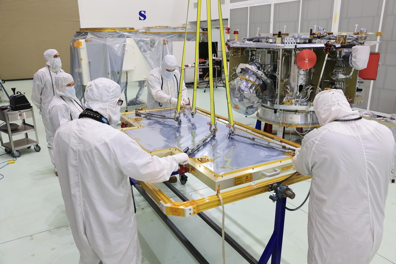 Technicians at the Astrotech Space Operations Facility near NASA’s Kennedy Space Center in Florida install the two-panel solar array on Thursday, July 17, 2025, that will help power the agency’s IMAP (Interstellar Mapping and Acceleration Probe) observatory on its upcoming journey one million miles away from Earth. Each panel of the solar array, located on the top of IMAP, consists of 16 strings of solar cells, with 36 cells per string, and combined will convert sunlight into 500 watts of power, more than enough for the observatory, which as a system uses less power than five 100-watt incandescent light bulbs.