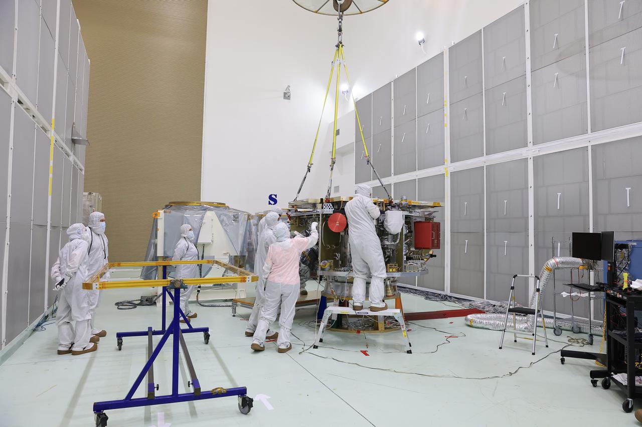 Technicians at the Astrotech Space Operations Facility near NASA’s Kennedy Space Center in Florida install the two-panel solar array on Thursday, July 17, 2025, that will help power the agency’s IMAP (Interstellar Mapping and Acceleration Probe) observatory on its upcoming journey one million miles away from Earth. Each panel of the solar array, located on the top of IMAP, consists of 16 strings of solar cells, with 36 cells per string, and combined will convert sunlight into 500 watts of power, more than enough for the observatory, which as a system uses less power than five 100-watt incandescent light bulbs.