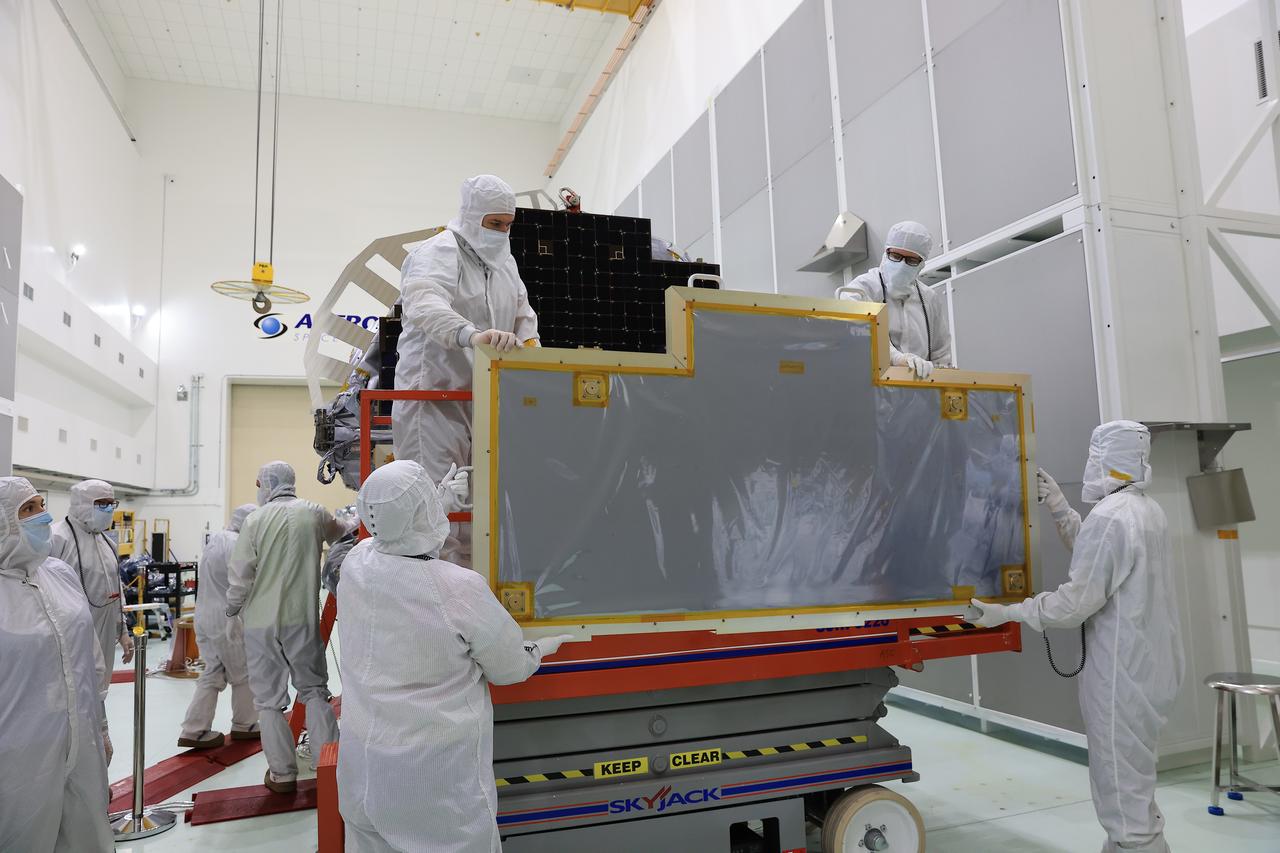 Technicians at the Astrotech Space Operations Facility near NASA’s Kennedy Space Center in Florida remove a protective covering from the two-panel solar array on Friday, July 18, 2025, that will help power the agency’s IMAP (Interstellar Mapping and Acceleration Probe) observatory on its upcoming journey to a destination about one million miles away from Earth at Lagrange Point 1. Each panel of the solar array, located on the top of IMAP, consists of 16 strings of solar cells, with 36 cells per string, and combined will convert sunlight into 500 watts of power, more than enough for the observatory, which as a system uses less power than five 100-watt incandescent light bulbs.  