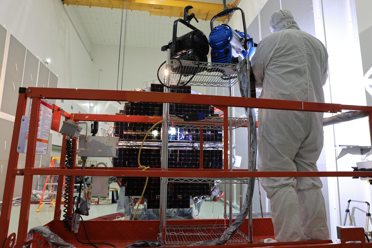 Technicians at the Astrotech Space Operations Facility near NASA’s Kennedy Space Center in Florida conduct illumination testing on Friday, July 18, 2025, by flashing a bright light that simulates the Sun into the two-panel solar array that will help power the agency’s IMAP (Interstellar Mapping and Acceleration Probe) observatory on its upcoming journey to a destination about one million miles away from Earth Lagrange Point 1. Each panel of the solar array, located on the top of IMAP, consists of 16 strings of solar cells, with 36 cells per string, and combined will convert sunlight into 500 watts of power, more than enough for the observatory, which as a system uses less power than five 100-watt incandescent light bulbs.  