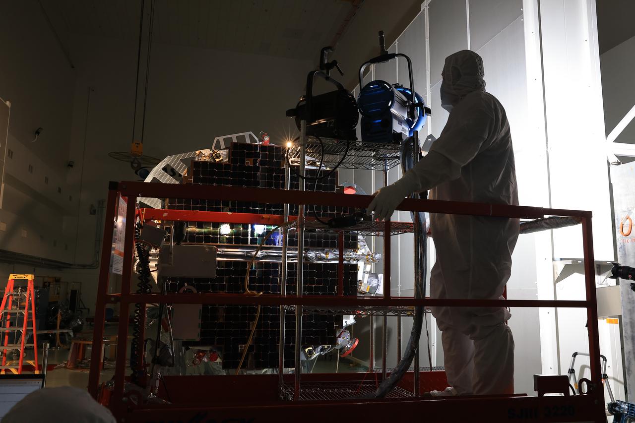 Technicians at the Astrotech Space Operations Facility near NASA’s Kennedy Space Center in Florida conduct illumination testing on Friday, July 18, 2025, by flashing a bright light that simulates the Sun into the two-panel solar array that will help power the agency’s IMAP (Interstellar Mapping and Acceleration Probe) observatory on its upcoming journey to a destination about one million miles away from Earth Lagrange Point 1. Each panel of the solar array, located on the top of IMAP, consists of 16 strings of solar cells, with 36 cells per string, and combined will convert sunlight into 500 watts of power, more than enough for the observatory, which as a system uses less power than five 100-watt incandescent light bulbs.  