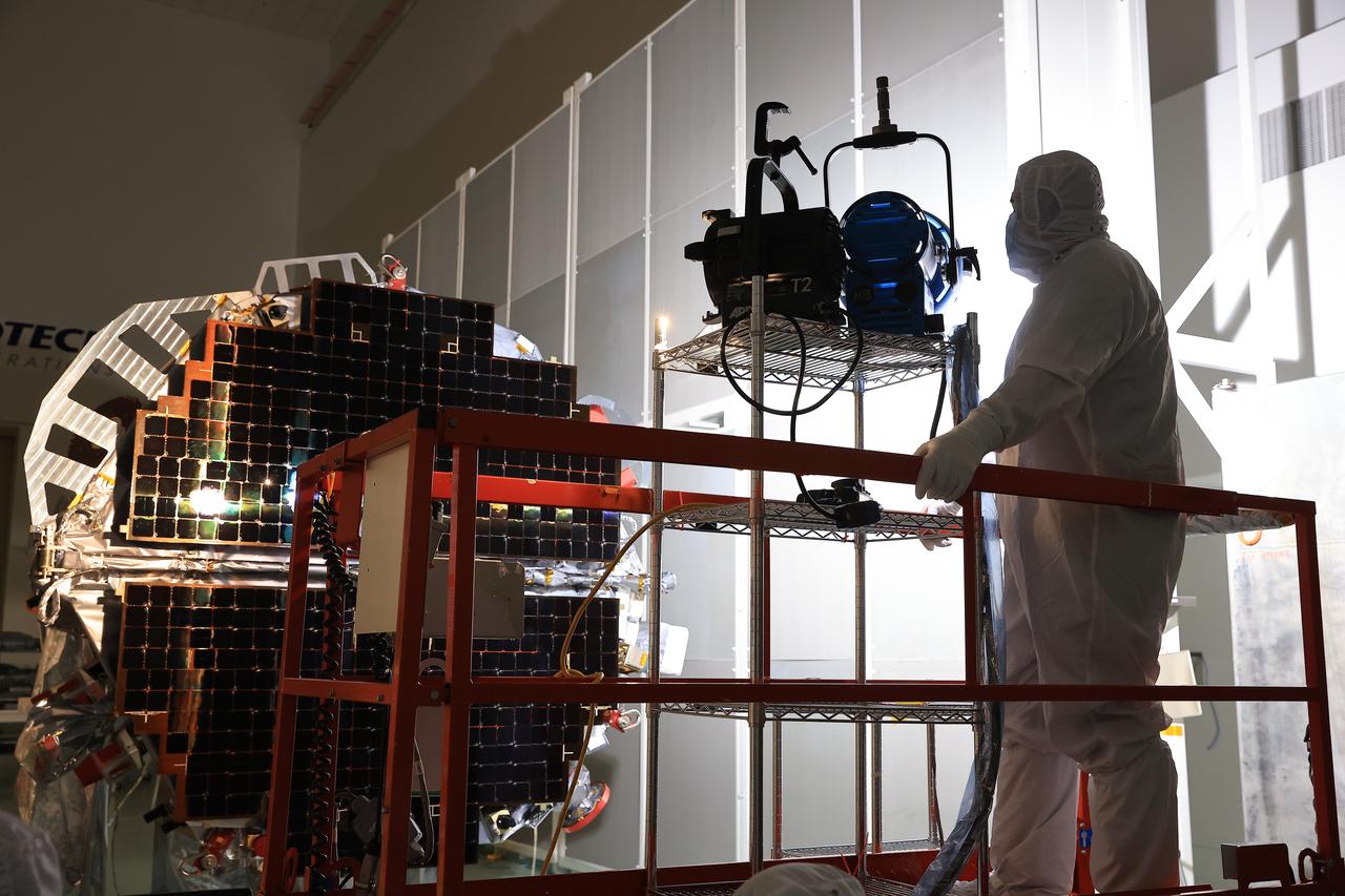 Technicians at the Astrotech Space Operations Facility near NASA’s Kennedy Space Center in Florida conduct illumination testing on Friday, July 18, 2025, by flashing a bright light that simulates the Sun into the two-panel solar array that will help power the agency’s IMAP (Interstellar Mapping and Acceleration Probe) observatory on its upcoming journey to a destination about one million miles away from Earth Lagrange Point 1. Each panel of the solar array, located on the top of IMAP, consists of 16 strings of solar cells, with 36 cells per string, and combined will convert sunlight into 500 watts of power, more than enough for the observatory, which as a system uses less power than five 100-watt incandescent light bulbs.  