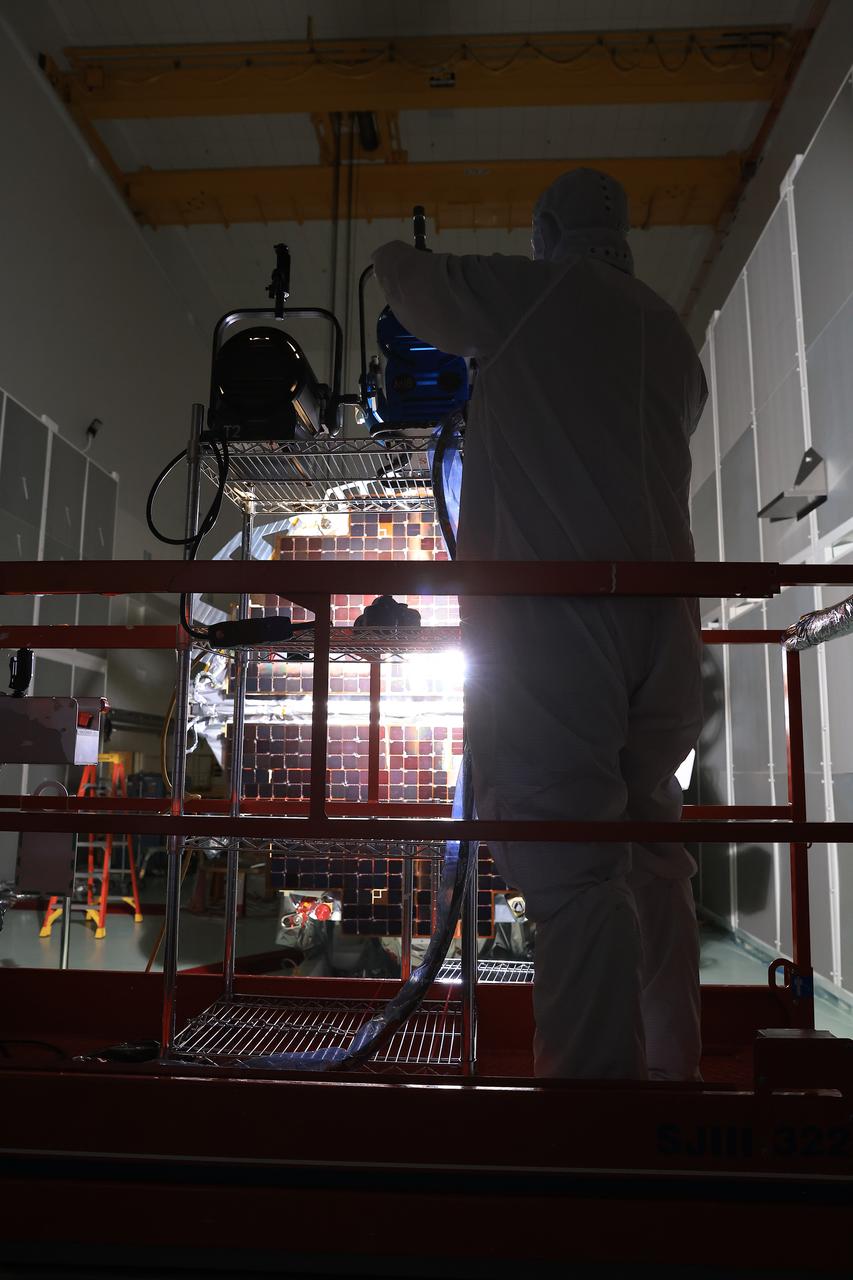 Technicians at the Astrotech Space Operations Facility near NASA’s Kennedy Space Center in Florida conduct illumination testing on Friday, July 18, 2025, by flashing a bright light that simulates the Sun into the two-panel solar array that will help power the agency’s IMAP (Interstellar Mapping and Acceleration Probe) observatory on its upcoming journey to a destination about one million miles away from Earth Lagrange Point 1. Each panel of the solar array, located on the top of IMAP, consists of 16 strings of solar cells, with 36 cells per string, and combined will convert sunlight into 500 watts of power, more than enough for the observatory, which as a system uses less power than five 100-watt incandescent light bulbs.  