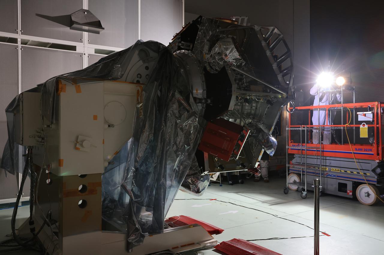 Technicians at the Astrotech Space Operations Facility near NASA’s Kennedy Space Center in Florida conduct illumination testing on Friday, July 18, 2025, by flashing a bright light that simulates the Sun into the two-panel solar array that will help power the agency’s IMAP (Interstellar Mapping and Acceleration Probe) observatory on its upcoming journey to a destination about one million miles away from Earth Lagrange Point 1. Each panel of the solar array, located on the top of IMAP, consists of 16 strings of solar cells, with 36 cells per string, and combined will convert sunlight into 500 watts of power, more than enough for the observatory, which as a system uses less power than five 100-watt incandescent light bulbs.  