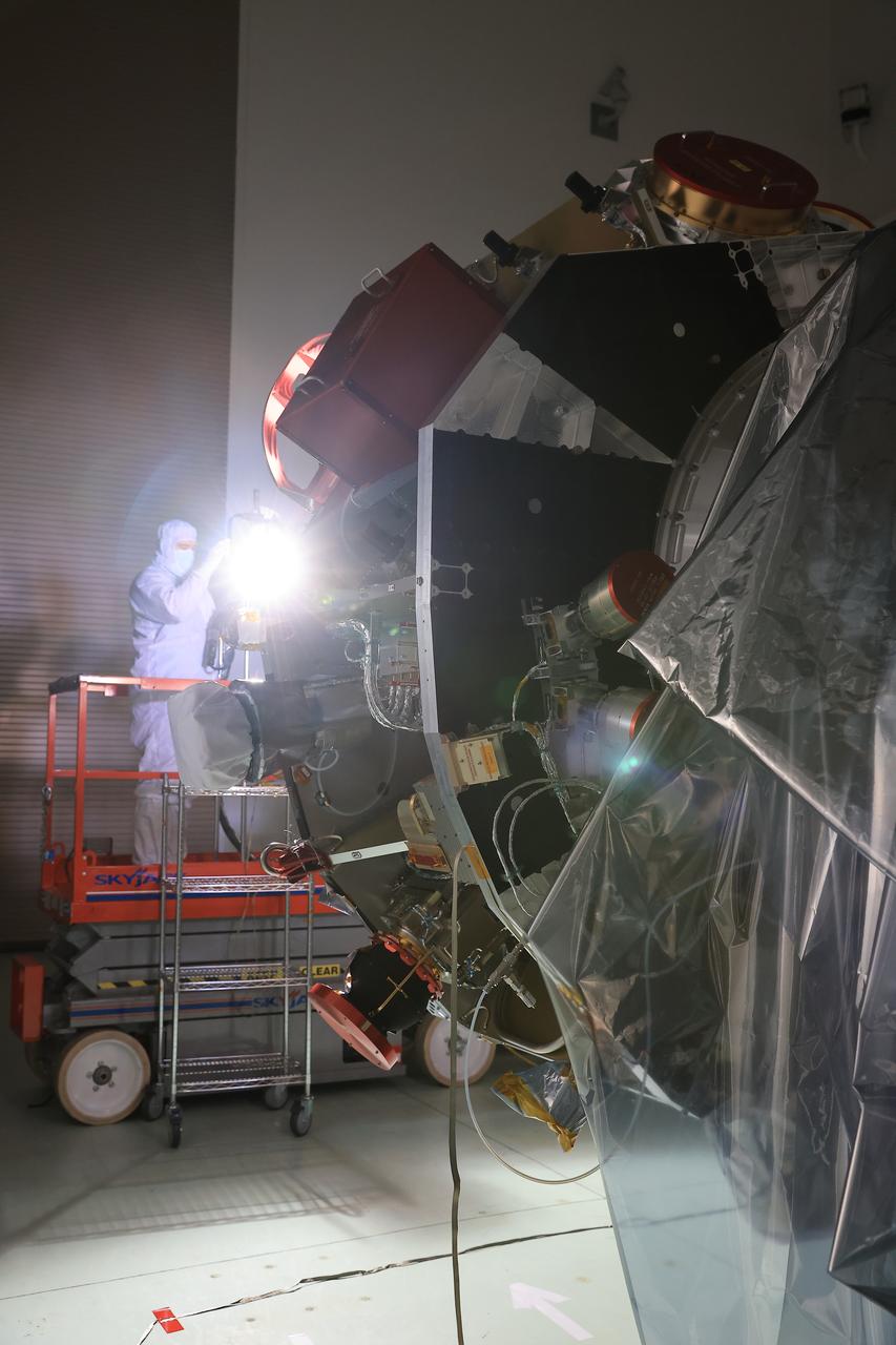 Technicians at the Astrotech Space Operations Facility near NASA’s Kennedy Space Center in Florida conduct illumination testing on Friday, July 18, 2025, by flashing a bright light that simulates the Sun into the two-panel solar array that will help power the agency’s IMAP (Interstellar Mapping and Acceleration Probe) observatory on its upcoming journey to a destination about one million miles away from Earth Lagrange Point 1. Each panel of the solar array, located on the top of IMAP, consists of 16 strings of solar cells, with 36 cells per string, and combined will convert sunlight into 500 watts of power, more than enough for the observatory, which as a system uses less power than five 100-watt incandescent light bulbs.  