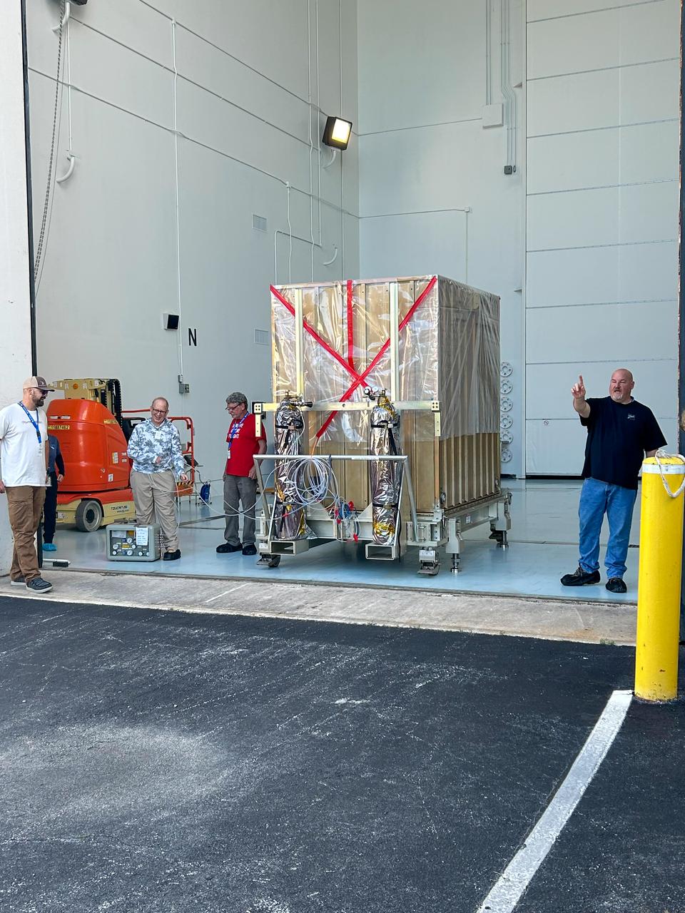 Technicians offloaded NASA’s Carruthers Geocorona Observatory following the spacecraft’s arrival on Monday, July 201, 2025, at the Astrotech Space Operations Facility near the agency’s Kennedy Space Center in Florida. The Carruthers Geocorona Observatory is a small satellite set to operate at Lagrange Point 1 (L1), an orbit point between the Earth and Sun about one million miles away, to study the Earth’s exosphere, the outermost part of the atmosphere. Carruthers will use its ultraviolet cameras to monitor how space weather from the Sun impacts the exosphere.