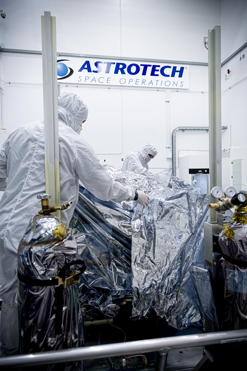 Technicians inspect NASA’s Carruthers Geocorona Observatory on Wednesday, July 23, 2025, following arrival and unboxing of the observatory at the Astrotech Space Operations Facility near the agency’s Kennedy Space Center in Florida. The Carruthers Geocorona Observatory is a small satellite set to operate at Lagrange Point 1 (L1), an orbit point between the Earth and Sun about one million miles away. Carruthers will use its ultraviolet cameras to monitor how space weather from the Sun impacts the exosphere, the outermost part of Earth’s atmosphere. The observatory will launch as a rideshare with NASA’s IMAP (Interstellar Mapping and Acceleration Probe) no earlier than September 2025.