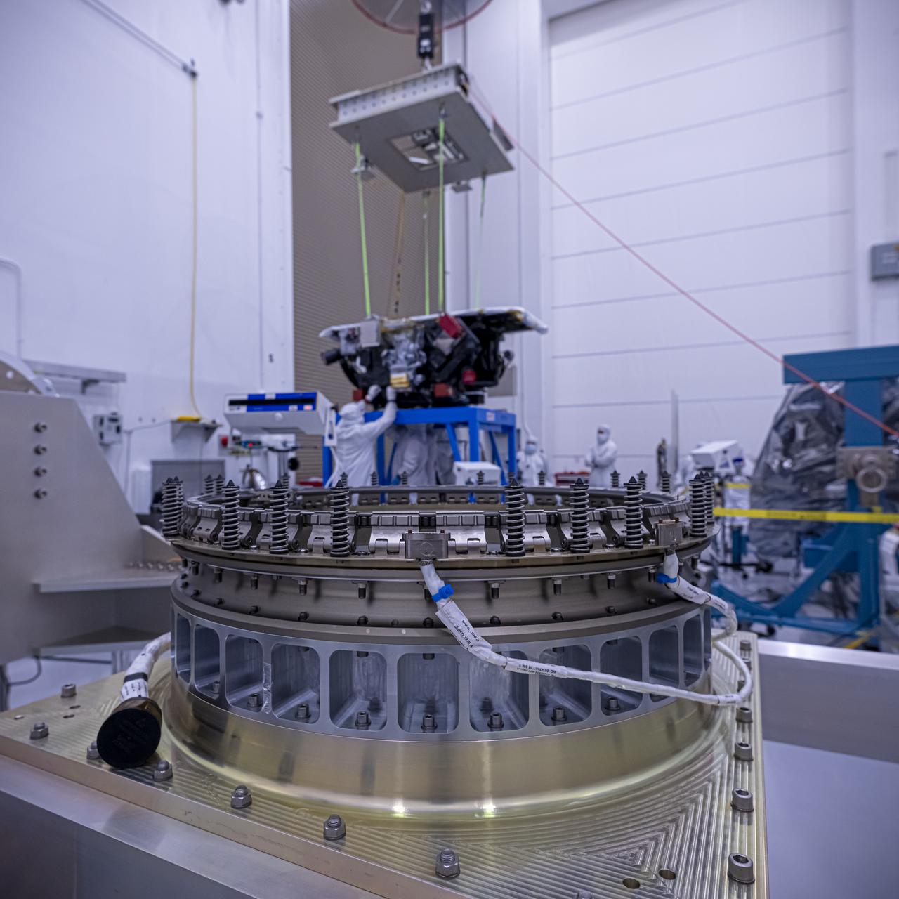 With hardware in the foreground, technicians use a crane to lift the National Oceanic and Atmospheric Administration’s (NOAA) Space Weather Follow On–Lagrange 1 (SWFO-L1) Observatory onto a work stand on Friday, July 25, 2025, during prelaunch processing at the Astrotech Space Operations Facility near NASA’s Kennedy Space Center in Florida. The SWFO-L1 mission will observe solar eruptions, and monitor incoming space weather 24/7, providing early warnings and validating forecasts that protect vital communication and navigation infrastructure, economic interests, and national security, both on Earth and in space. The observatory will launch as a rideshare with NASA’s IMAP (Interstellar Mapping and Acceleration Probe) no earlier than September 2025.