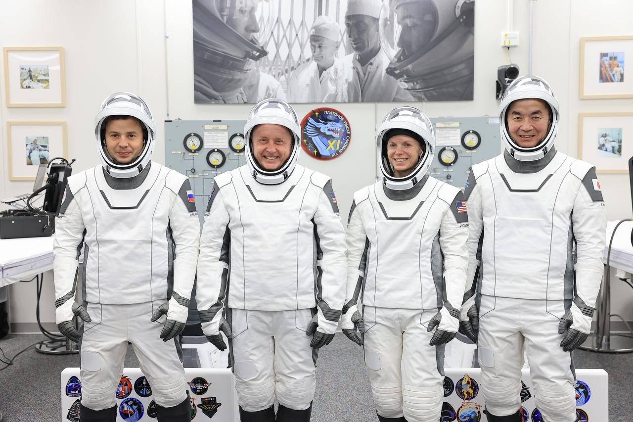 From right to left, NASA’s SpaceX Crew-11 crew members JAXA (Japan Aerospace Exploration Agency) astronaut Kimiya Yui, along with NASA astronauts Zena Cardman and Mike Fincke, as well as Roscosmos cosmonaut Oleg Platonov pose for a photo inside the crew suit-up room in the Neil A. Armstrong Operations and Checkout Building at the agency’s Kennedy Space Center in Florida during a countdown dress rehearsal on Monday, July 28, 2025. The crew will launch to the International Space Station aboard SpaceX’s Dragon spacecraft and Falcon 9 rocket at 12:09 p.m. EDT on Thursday, July 31, 2025, from NASA Kennedy’s Launch Complex 39A. 