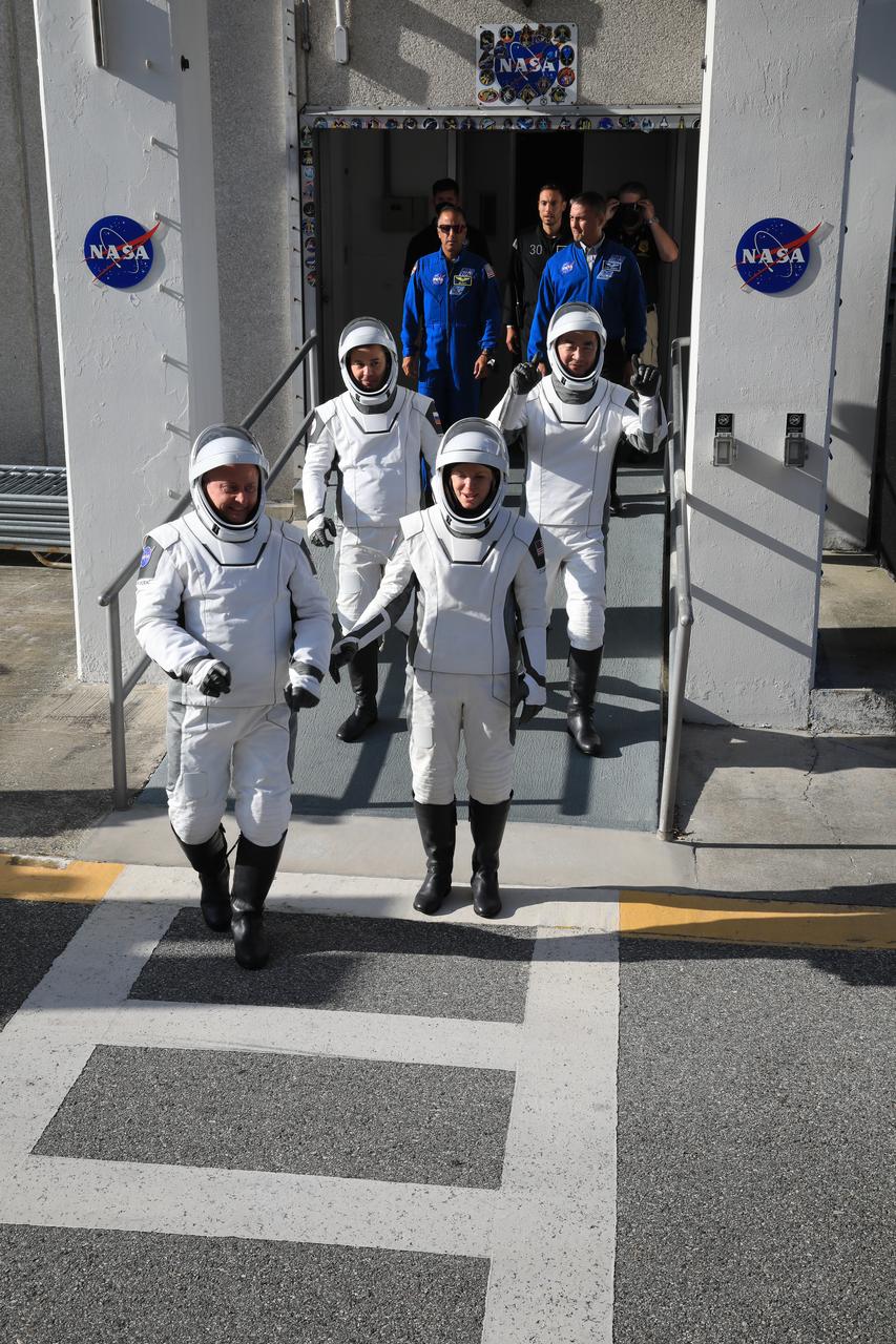 NASA’s SpaceX Crew-11 crew members walk out of the Neil A. Armstrong Operations and Checkout Building at the agency’s Kennedy Space Center in Florida during a countdown dress rehearsal on Monday, July 28, 2025. From top left to right, NASA astronauts Mike Fincke and Zena Cardman, along with Roscosmos cosmonaut Oleg Platonov and JAXA (Japan Aerospace Exploration Agency) astronaut Kimiya Yui will launch to the International Space Station aboard SpaceX’s Dragon spacecraft and Falcon 9 rocket at 12:09 p.m. EDT on Thursday, July 31, 2025, from Launch Complex 39A at NASA Kennedy.