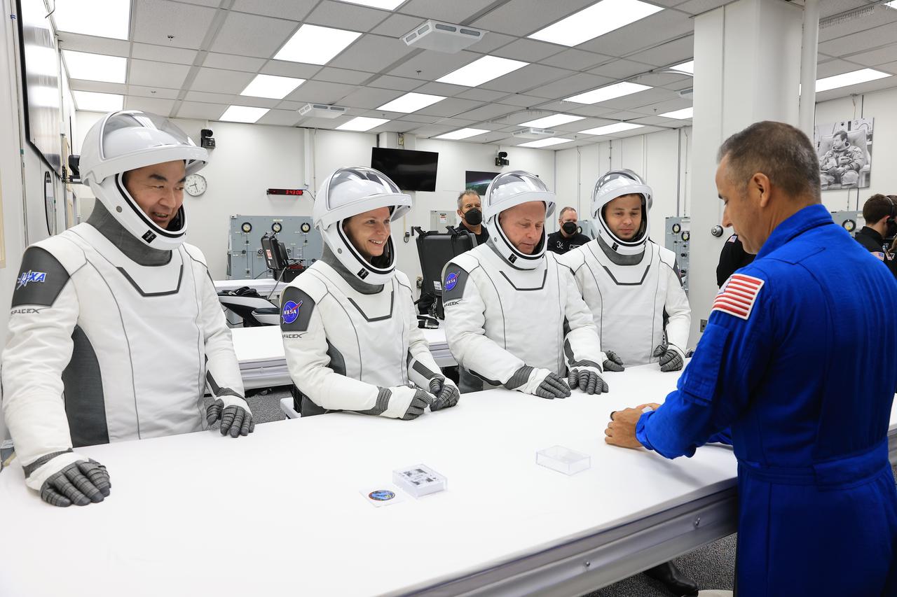NASA’s SpaceX Crew-11 members play the traditional card game with NASA astronaut chief Joe Acaba, inside the Neil A. Armstrong Operations and Checkout Building at the agency’s Kennedy Space Center in Florida on Thursday, July 31, 2025, during its first attempt to the International Space Station. From left to right, JAXA (Japan Aerospace Exploration Agency) astronaut Kimiya Yui, NASA astronauts Zena Cardman and Mike Fincke, along with Roscosmos cosmonaut Oleg Platonov are scheduled to lift off aboard SpaceX’s Dragon spacecraft and Falcon 9 rocket for its second attempt at 11:43 a.m. EDT Friday, Aug. 1, 2025, from Launch Complex 39A at NASA Kennedy.