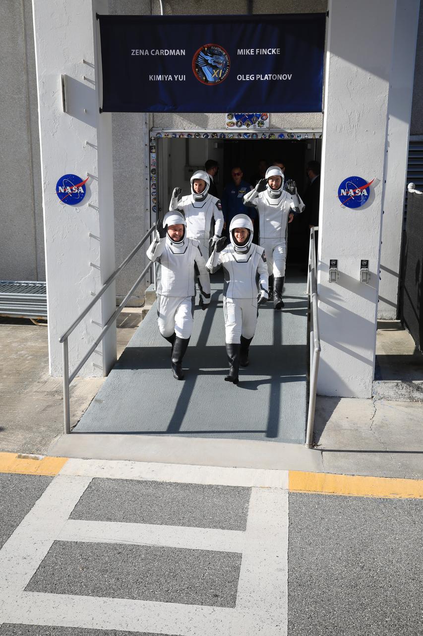 From front left NASA astronauts Mike Fincke and Zena Cardman, along with Roscosmos cosmonaut Oleg Platonov and JAXA (Japan Aerospace Exploration Agency) astronaut Kimiya Yui, walk out of the Neil A. Armstrong Operations and Checkout Building at the agency’s Kennedy Space Center in Florida on Thursday, July 31, 2025, during the first attempt of NASA’s SpaceX Crew-11 mission to the International Space Station. From top left, NASA astronauts Mike Fincke and Zena Cardman, along with JAXA (Japan Aerospace Exploration Agency) astronaut Kimiya Yui and Roscosmos cosmonaut Oleg Platonov, are scheduled to lift off aboard SpaceX’s Dragon spacecraft and Falcon 9 rocket for its second attempt at 11:43 a.m. EDT Friday, Aug. 1, 2025, from Launch Complex 39A at NASA Kennedy. 