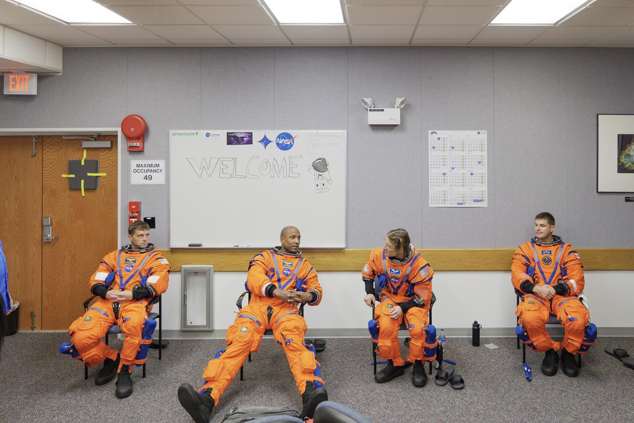 The crew of NASA’s Artemis II mission participates in a suited crew test on Thursday, July 31, 2025, at the agency’s Kennedy Space Center in Florida. From left, NASA astronauts Reid Wiseman, Artemis II commander; Victor Glover, Artemis II pilot; and Christina Koch, mission specialist; along with CSA (Canadian Space Agency) astronaut Jeremy Hansen,. mission specialist,  donned their Orion crew survival system spacesuits for training at NASA’s Kennedy’s Multi-Payload Processing Facility, where they entered their fully powered Orion spacecraft as part of the test. Artemis II will take the four astronauts around the Moon, as the first crewed mission on NASA’s path to establishing a long-term presence for science and exploration through Artemis.