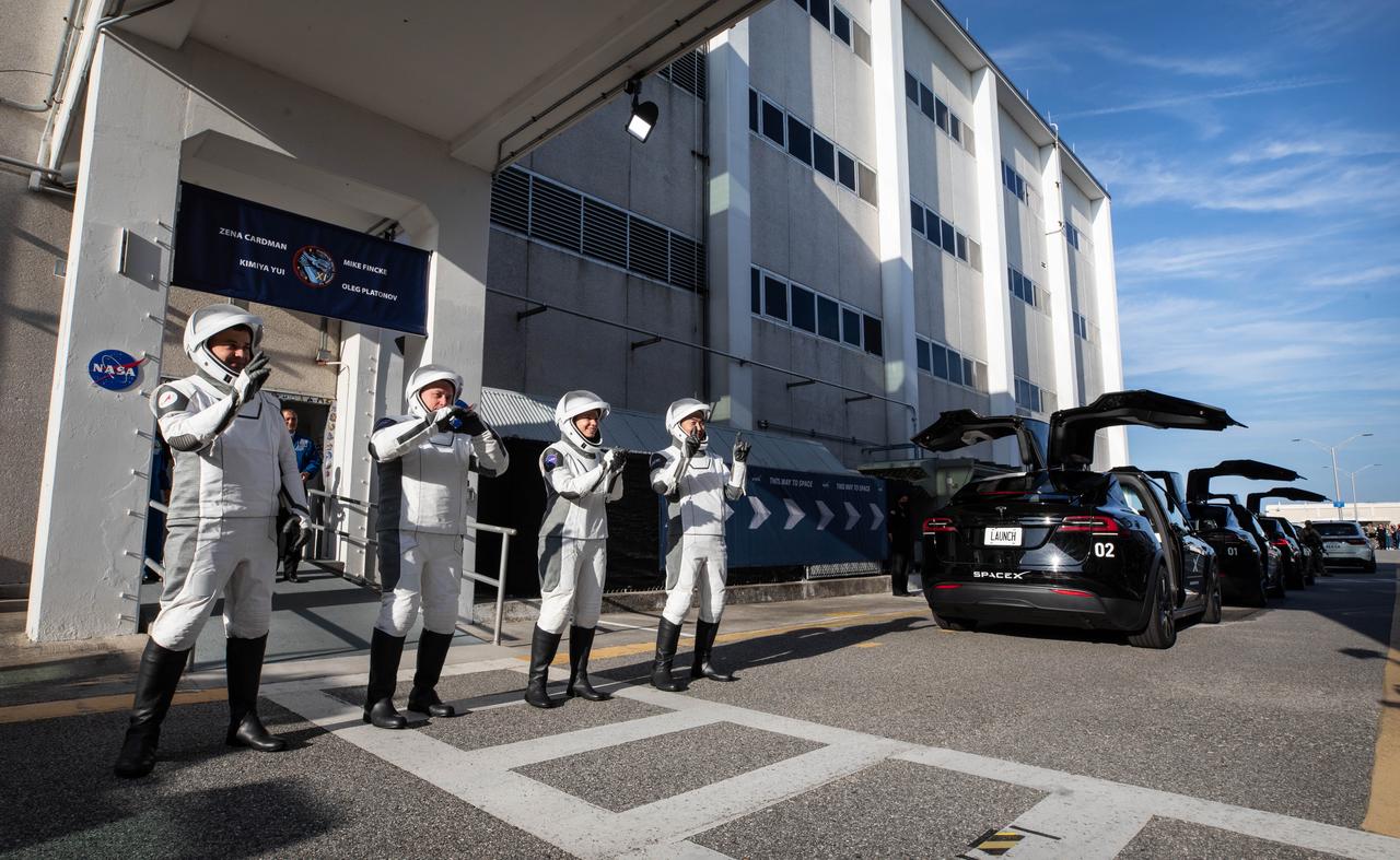 From right to left, JAXA (Japan Aerospace Exploration Agency) astronaut Kimiya Yui, NASA astronauts Zena Cardman and Mike Fincke, along with and Roscosmos cosmonaut Oleg Platonov wave to family and friends as they walk out of the Neil A. Armstrong Operations and Checkout Building at the agency’s Kennedy Space Center in Florida during the second launch attempt of NASA’s SpaceX Crew-11 mission to the International Space Station on Friday, Aug. 1, 2025. Crew-11 is scheduled to lift off aboard SpaceX’s Dragon spacecraft and Falcon 9 rocket at 11:43 a.m. EDT, from Launch Complex 39A at NASA Kennedy.