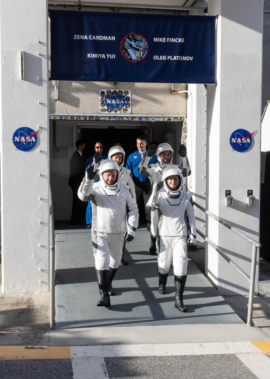 From top left NASA astronauts Mike Fincke and Zena Cardman, along with JAXA (Japan Aerospace Exploration Agency) astronaut Kimiya Yui and Roscosmos cosmonaut Oleg Platonov wave to family and friends as they walk out of the Neil A. Armstrong Operations and Checkout Building at the agency’s Kennedy Space Center in Florida during the second launch attempt of NASA’s SpaceX Crew-11 mission to the International Space Station on Friday, Aug. 1, 2025. Crew-11 is scheduled to lift off aboard SpaceX’s Dragon spacecraft and Falcon 9 rocket at 11:43 a.m. EDT, from Launch Complex 39A at NASA Kennedy.