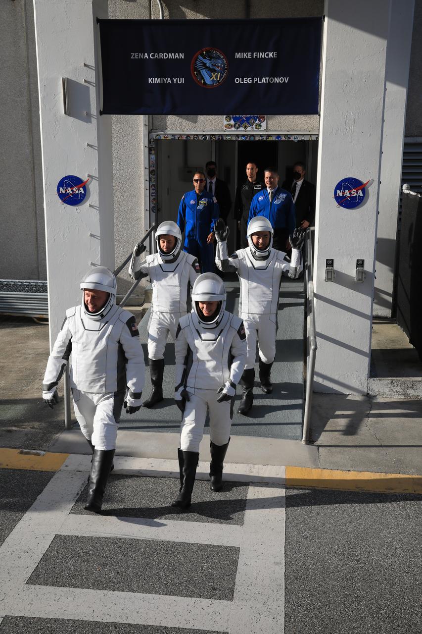 From front left NASA astronauts Mike Fincke and Zena Cardman, along with JAXA (Japan Aerospace Exploration Agency) astronaut Kimiya Yui and Roscosmos cosmonaut Oleg Platonov wave to family and friends as they walk out of the Neil A. Armstrong Operations and Checkout Building at the agency’s Kennedy Space Center in Florida during the second launch attempt of NASA’s SpaceX Crew-11 mission to the International Space Station on Friday, Aug. 1, 2025. Crew-11 is scheduled to lift off aboard SpaceX’s Dragon spacecraft and Falcon 9 rocket at 11:43 a.m. EDT, from Launch Complex 39A at NASA Kennedy.