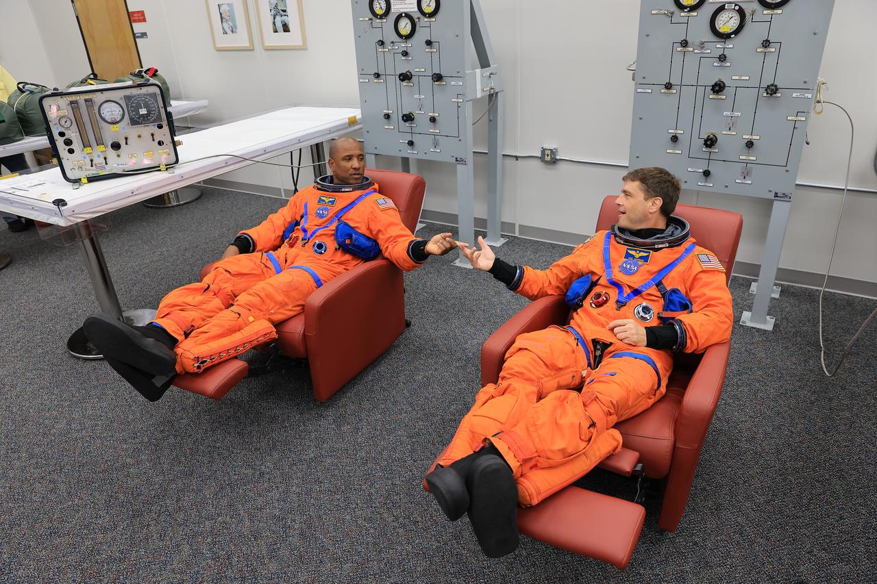 From left to right, NASA astronauts Victor Glover, Artemis II pilot and Reid Wiseman, Artemis II commander, conduct suit-up operations inside the Neil A. Armstrong Operations and Checkout Building at NASA’s Kennedy Space Center in Florida on Monday, Aug. 11, 2025. During a two-day operation, the Artemis II team practiced night-run demonstrations of different launch day scenarios like suit-up operations, walk-out, and arriving at the launch pad for the Artemis II test flight. Through the Artemis campaign, NASA will send astronauts to explore the Moon for scientific discovery, economic benefits, and to build the foundation for the first crewed missions to Mars – for the benefit of all.   