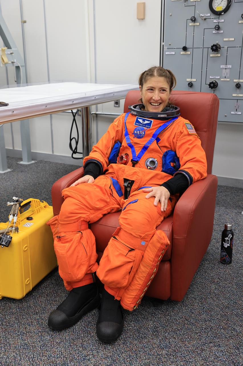 NASA astronaut Christina Koch, Artemis II mission specialist, smiles during suit-up operations inside the Neil A. Armstrong Operations and Checkout Building at NASA’s Kennedy Space Center in Florida on Monday, Aug. 11, 2025. During a two-day operation, the Artemis II team practiced night-run demonstrations of different launch day scenarios like suit-up operations, walk-out, and arriving at the launch pad for the Artemis II test flight. Through the Artemis campaign, NASA will send astronauts to explore the Moon for scientific discovery, economic benefits, and to build the foundation for the first crewed missions to Mars – for the benefit of all. 