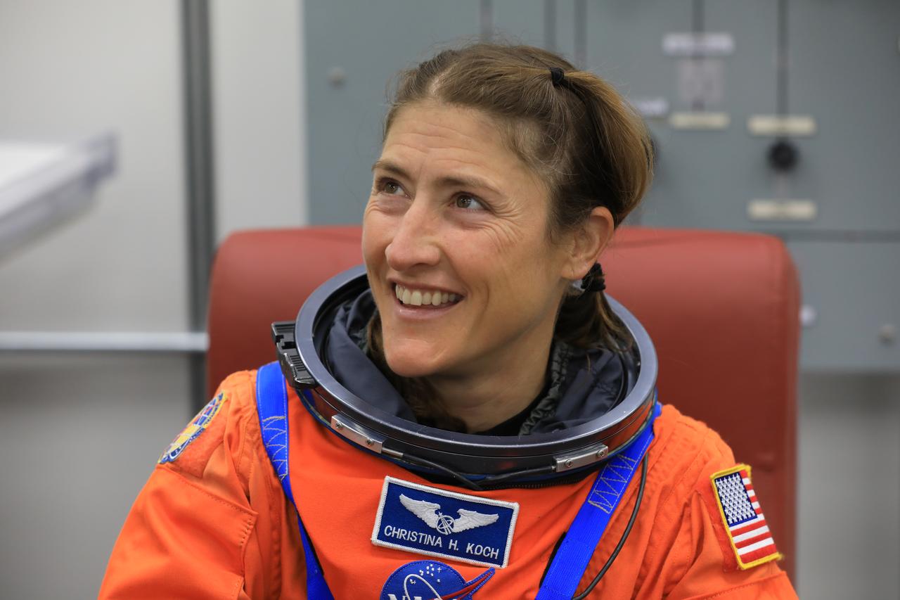 NASA astronaut Christina Koch, Artemis II mission specialist, smiles during suit-up operations inside the Neil A. Armstrong Operations and Checkout Building at NASA’s Kennedy Space Center in Florida on Monday, Aug. 11, 2025. During a two-day operation, the Artemis II team practiced night-run demonstrations of different launch day scenarios like suit-up operations, walk-out, and arriving at the launch pad for the Artemis II test flight. Through the Artemis campaign, NASA will send astronauts to explore the Moon for scientific discovery, economic benefits, and to build the foundation for the first crewed missions to Mars – for the benefit of all. 