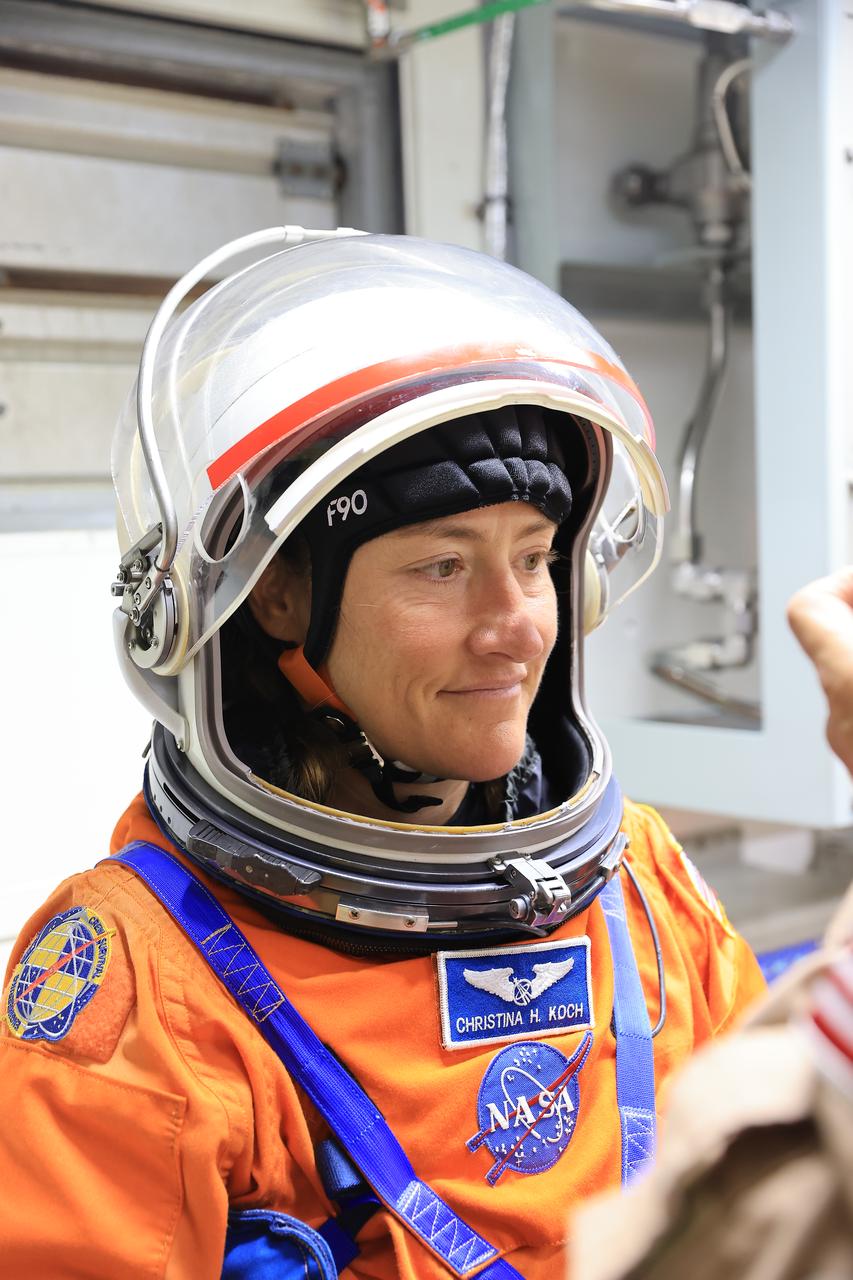 NASA astronaut Christina Koch, Artemis II mission specialist, stands in the White Room on the crew access arm of the mobile launcher in the Vehicle Assembly Building at NASA’s Kennedy Space Center in Florida on Tuesday, Aug. 12, 2025. During a two-day operation, the Artemis II team practiced night-run demonstrations of different launch day scenarios like suit-up operations, walk-out, and arriving at the launch pad for the Artemis II test flight. Through the Artemis campaign, NASA will send astronauts to explore the Moon for scientific discovery, economic benefits, and to build the foundation for the first crewed missions to Mars – for the benefit of all.   