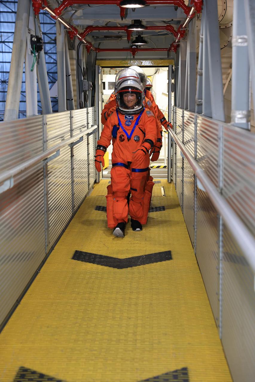 NASA astronaut Christina Koch, Artemis II mission specialist, and the remaining Artemis II crew members walk on the crew access arm of the mobile launcher in the Vehicle Assembly Building at NASA’s Kennedy Space Center in Florida on Tuesday, Aug. 12, 2025. During a two-day operation, the Artemis II team practiced night-run demonstrations of different launch day scenarios like suit-up operations, walk-out, and arriving at the launch pad for the Artemis II test flight. Through the Artemis campaign, NASA will send astronauts to explore the Moon for scientific discovery, economic benefits, and to build the foundation for the first crewed missions to Mars – for the benefit of all.   