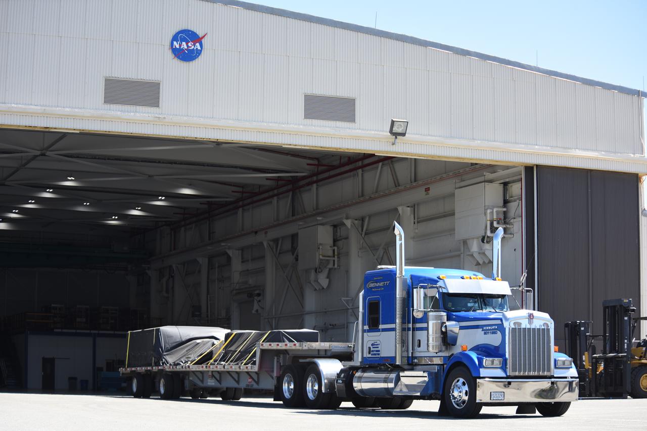 Wrapped in protective coverings, ground support equipment for the Sentinel-6B spacecraft, a collaboration between NASA, ESA (European Space Agency), EUMETSAT (European Organisation for the Exploitation of Meteorological Satellites), and the National Oceanic and Atmospheric Administration (NOAA), arrives by truck to NASA’s Building 836 at Vandenberg Space Force Base in California on Monday, Aug. 18, 2025. The second of two spacecraft that constitutes the Sentinel-6/Jason-CS (Continuity of Service) mission, Sentinel-6B will measure sea surface height and provide crucial information to help improve coastal planning, enabling local and state governments to make informed decisions about protecting coastal infrastructure, real estate, and energy sites. Launch is targeted for no earlier than November on a SpaceX Falcon 9 from Vandenberg.