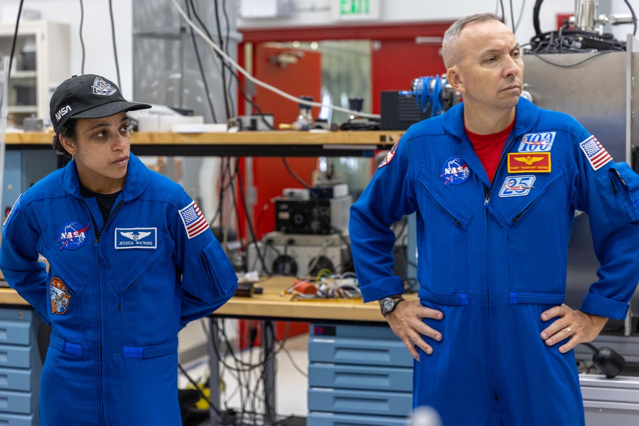 NASA astronauts Jessica Watkins and Randy Bresnik visit the Granular Mechanics and Regolith Operations Laboratory inside Swamp Works at Kennedy Space Center in Florida on Wednesday, Aug. 27, 2025, to view some of the evolving technologies in development that astronauts may use to explore the Moon’s surface, prepare it for sustainable outposts, and to handle the dust that is collected during moonwalks.