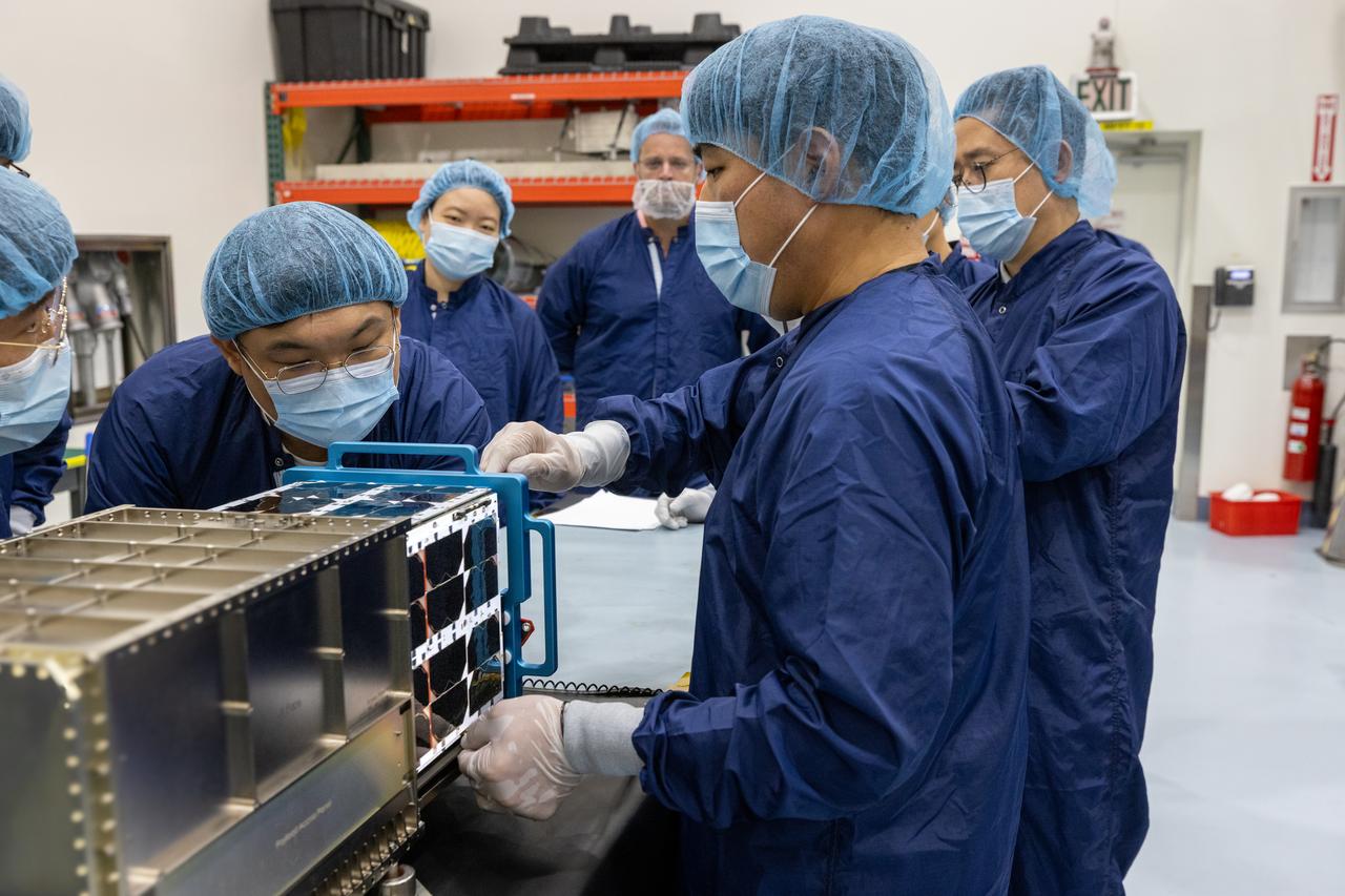 Inside the Multi-Payload Processing Facility at NASA’s Kennedy Space Center in Florida, on Wednesday, Aug. 27, 2025, technicians with the Korea AeroSpace Administration (KASA) complete closeouts on the K-Rad Cube, one of several international CubeSats slated to fly on NASA’s Artemis II test flight in 2026. Deploying in high Earth orbit from a spacecraft adapter on NASA’s SLS (Space Launch System) rocket after Orion is safely flying on its own with its crew of four astronauts, K-Rad Cube will use a dosimeter made of material designed to mimic human tissue to measure space radiation and assess biological effects at various altitudes across the Van Allen radiation belts, a critical area of research for human presence at the Moon and Mars.
